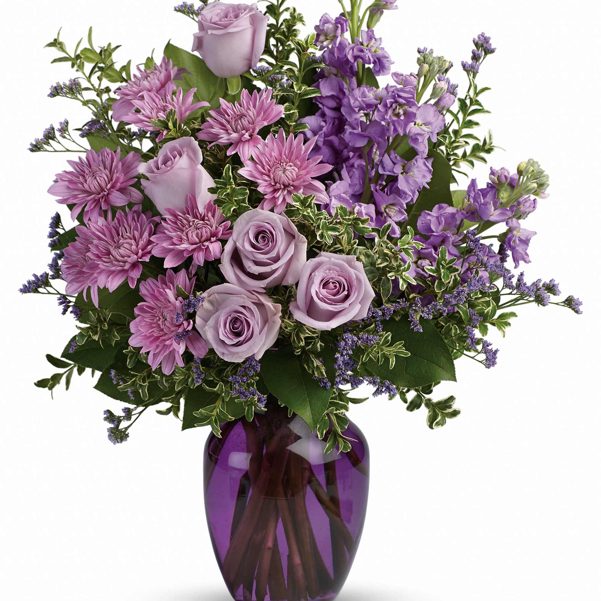 Lavender roses and purple flowers in a purple glass vase