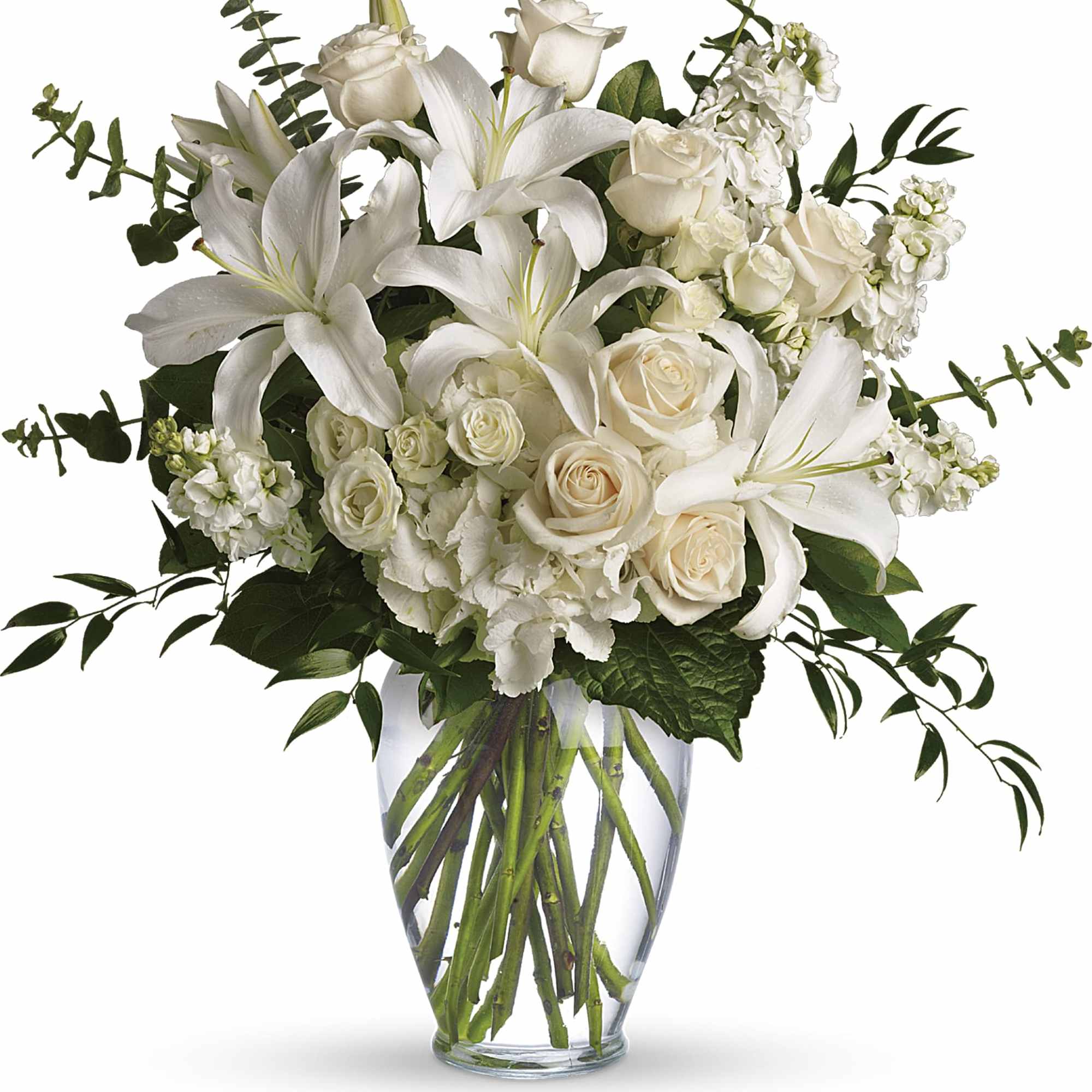 White lilies and cream roses in a clear glass vase
