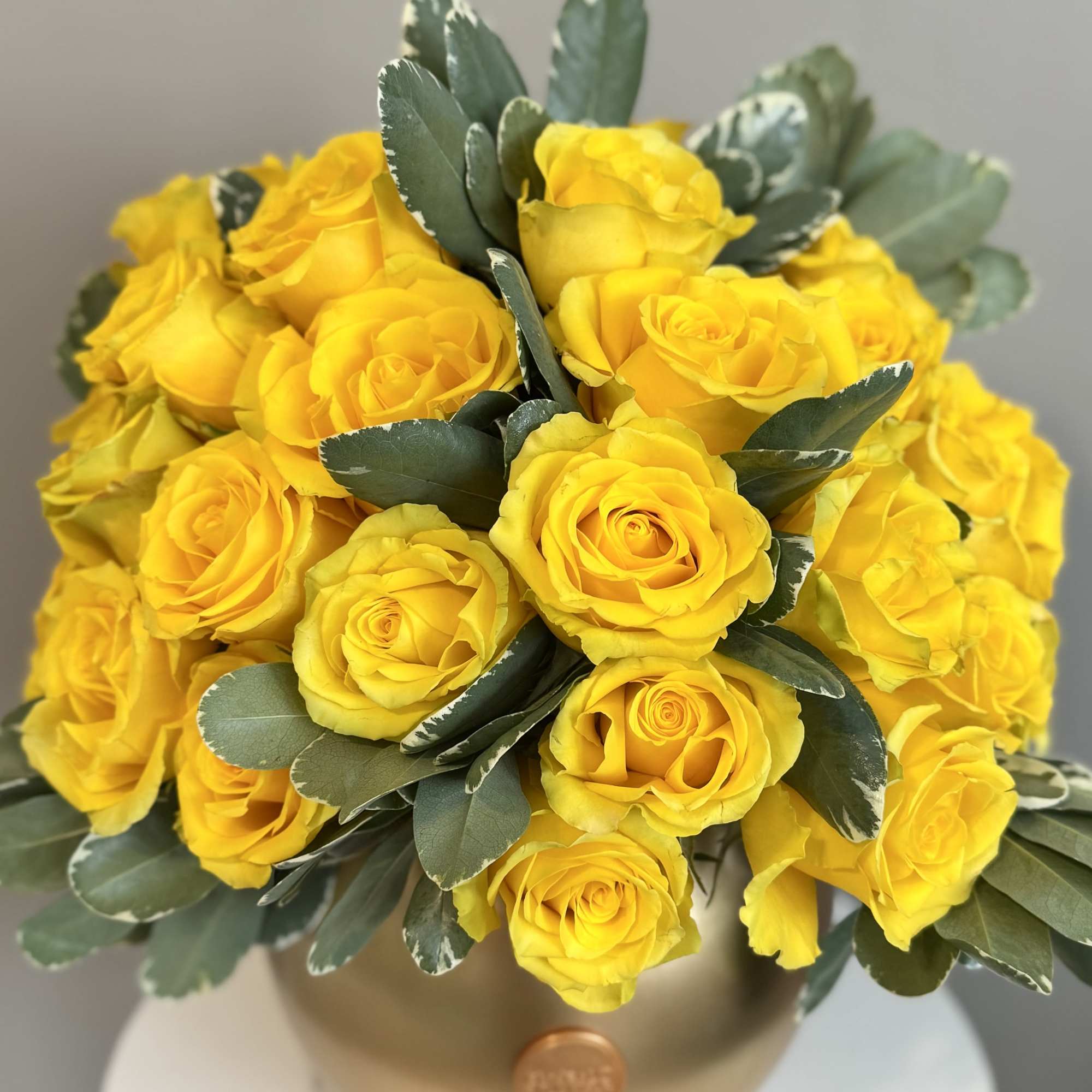 Bouquet of yellow roses in a gold vase