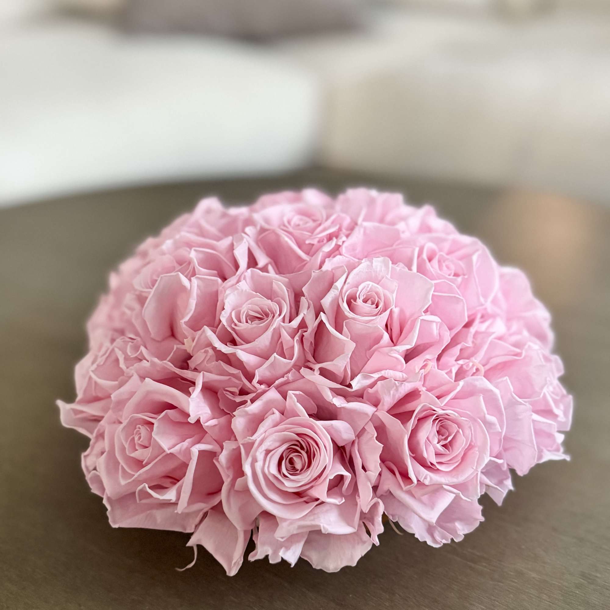 Round bouquet of pink roses on a table