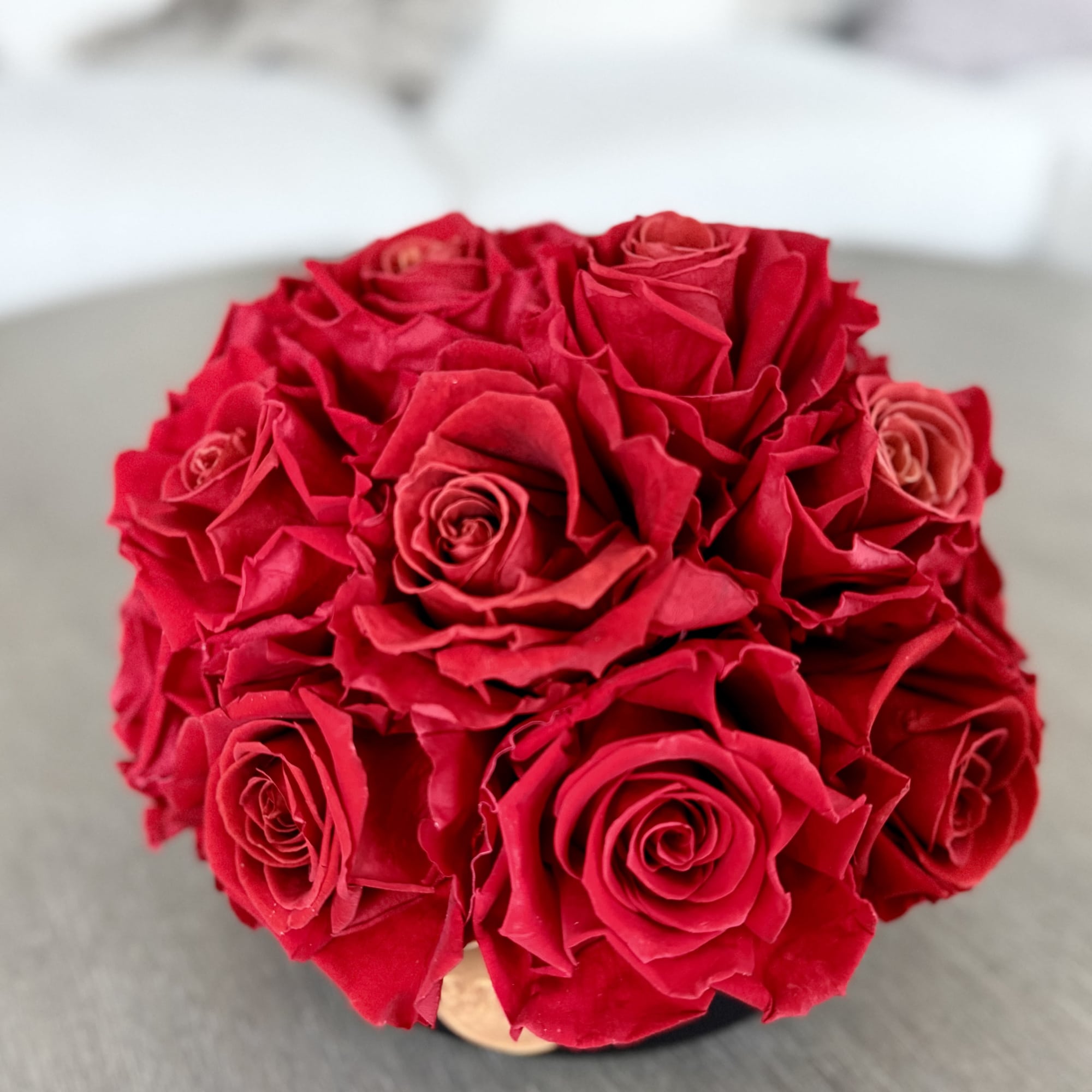 Bouquet of red roses in a low round arrangement