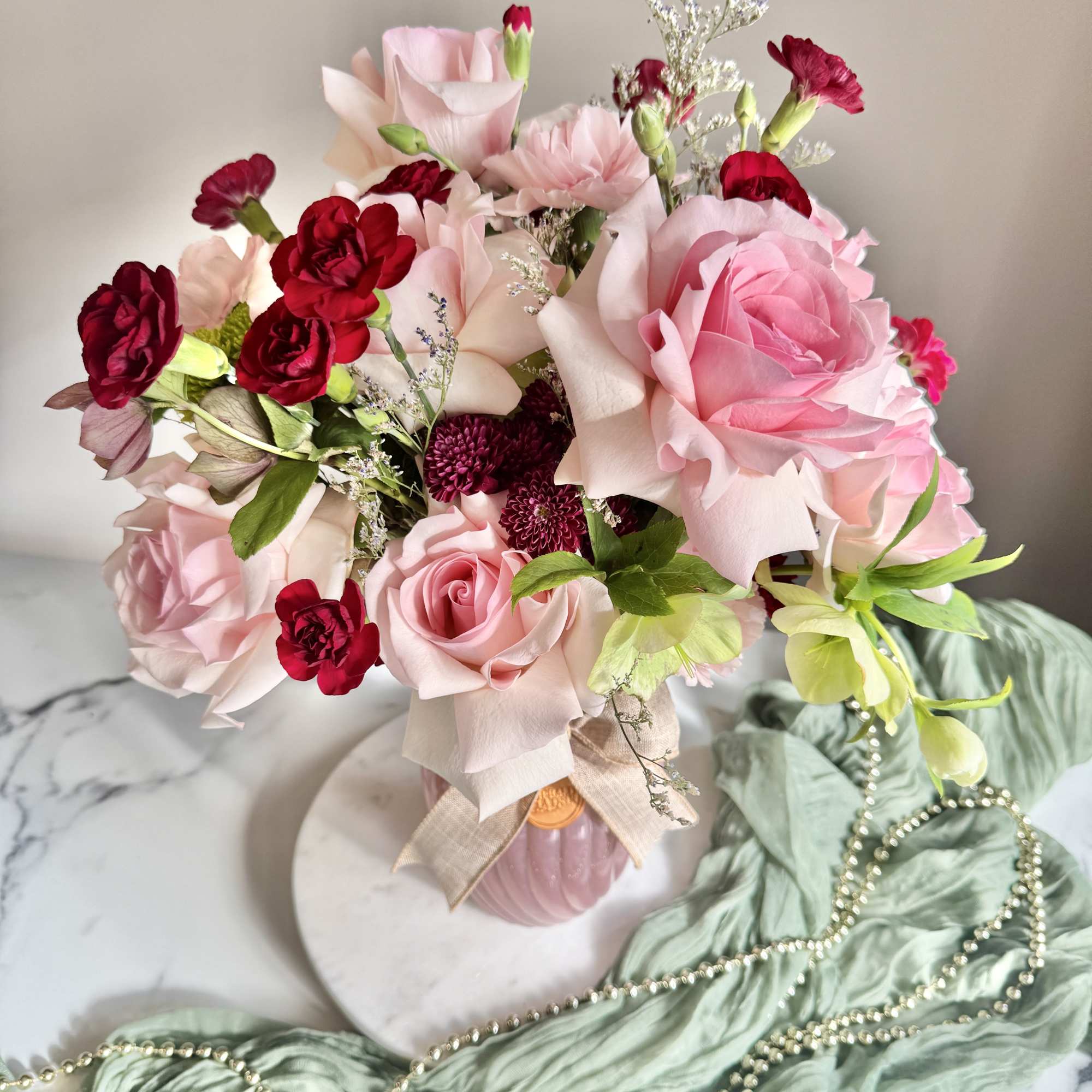 Pink and red rose bouquet in a pink vase