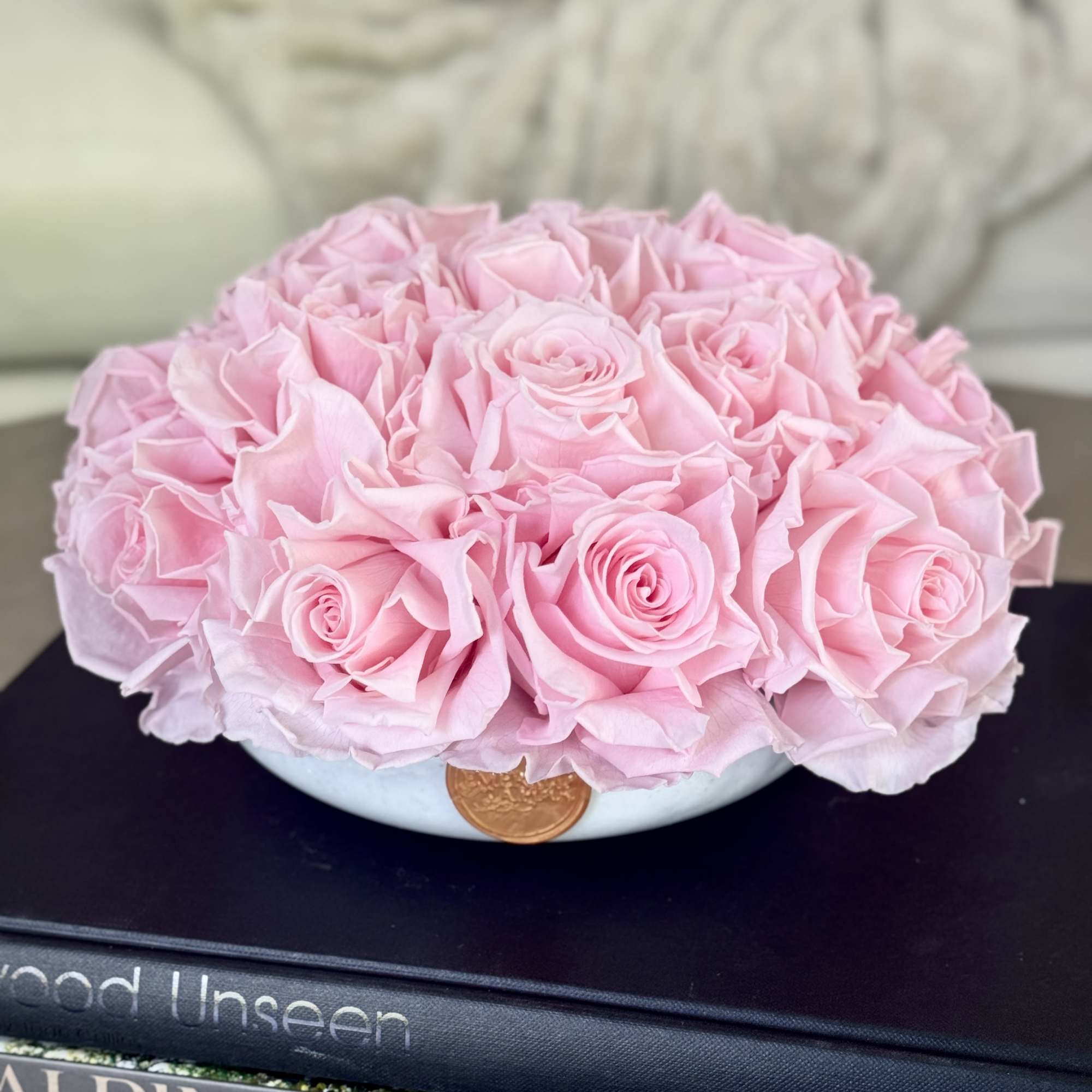 Pink roses arranged in a low round bowl