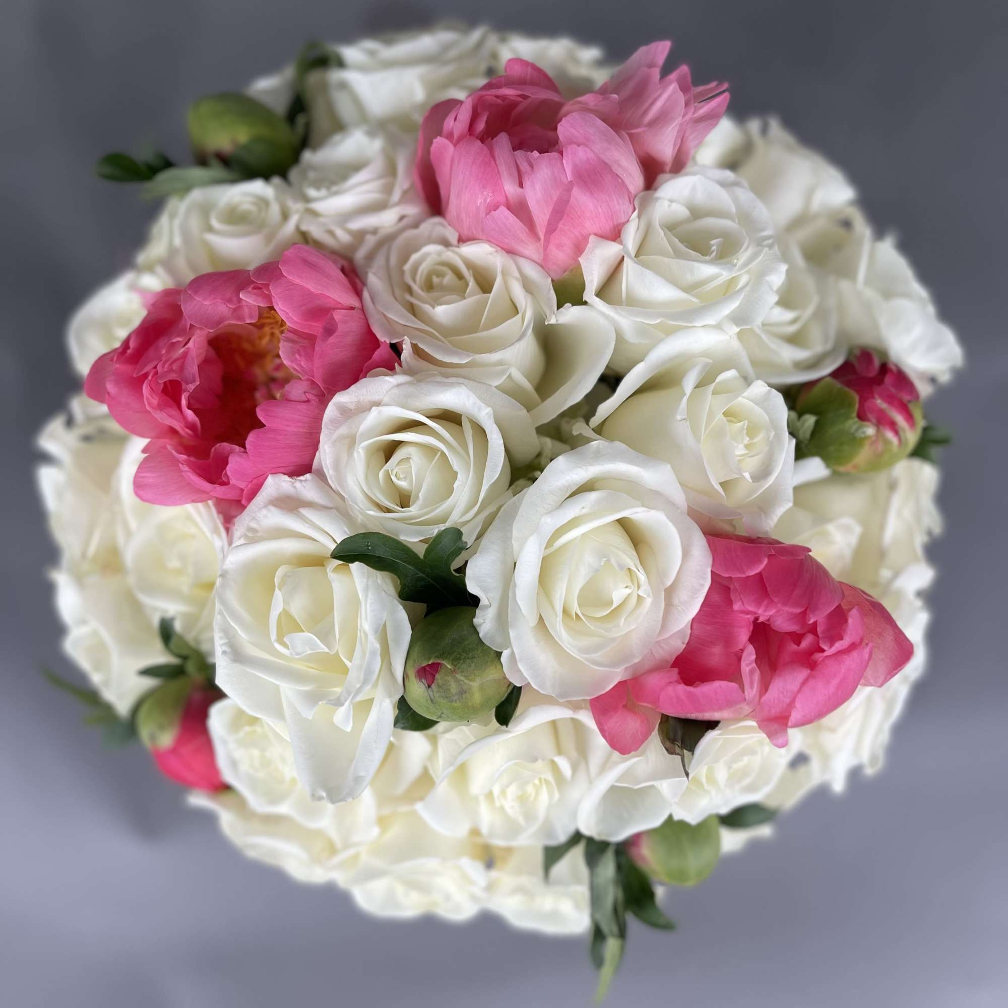 Bouquet of white roses and bright pink peonies