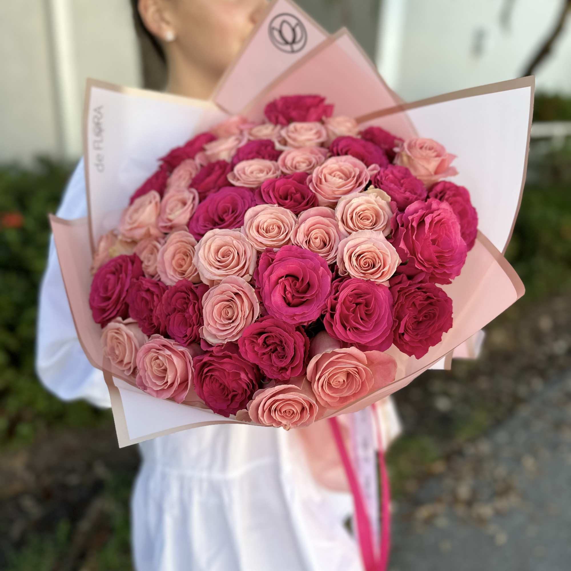 Large bouquet of pink and blush roses wrapped in pastel paper