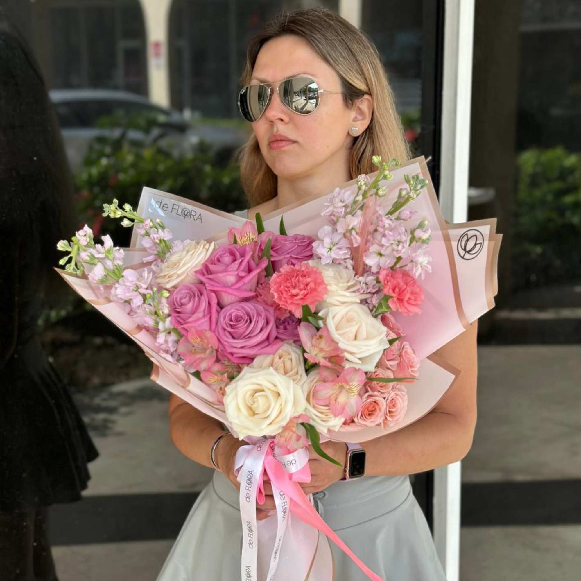 Large bouquet of pink and white roses with pastel wrapping
