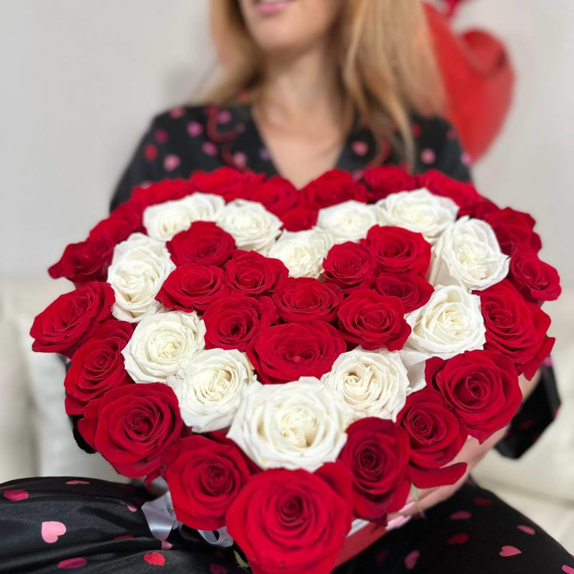 Heart-shaped bouquet of red and white roses