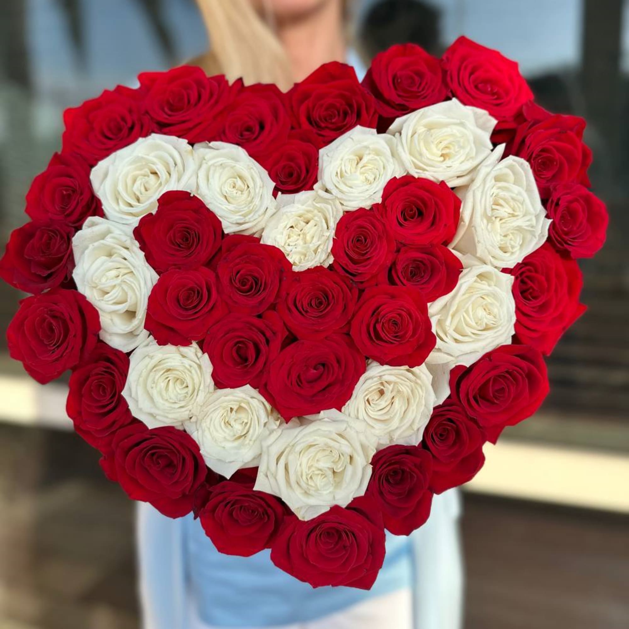 Heart-shaped bouquet of red and white roses