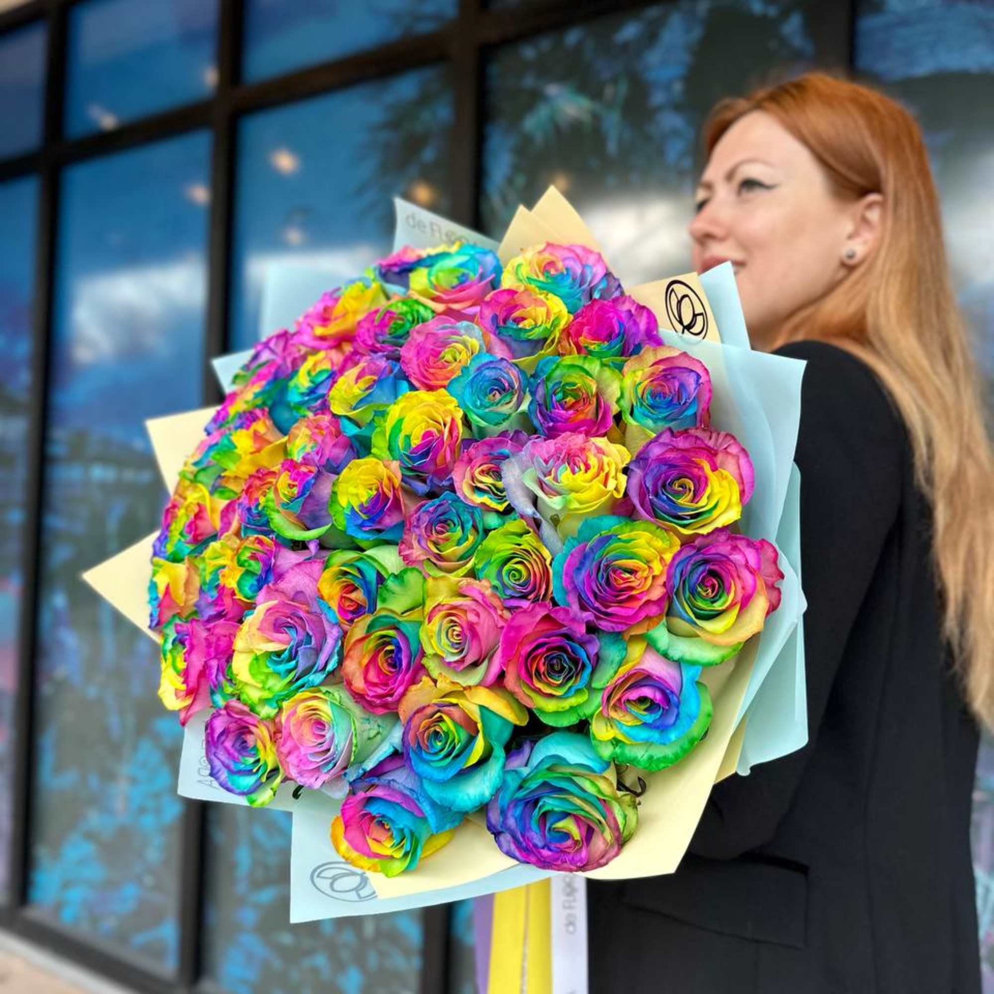 Large bouquet of rainbow-colored roses wrapped in pale paper, photo 2 of 5