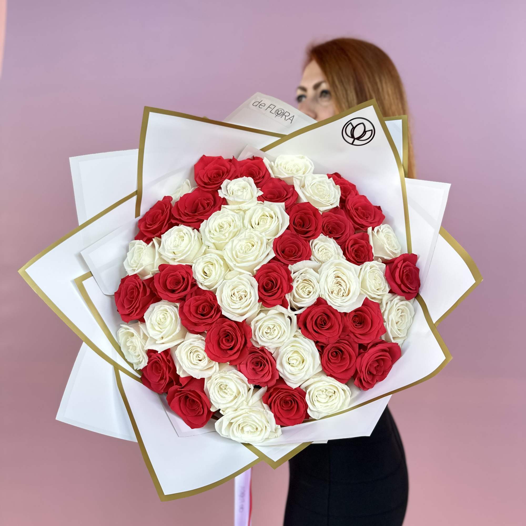 Large bouquet of red and white roses wrapped in white paper