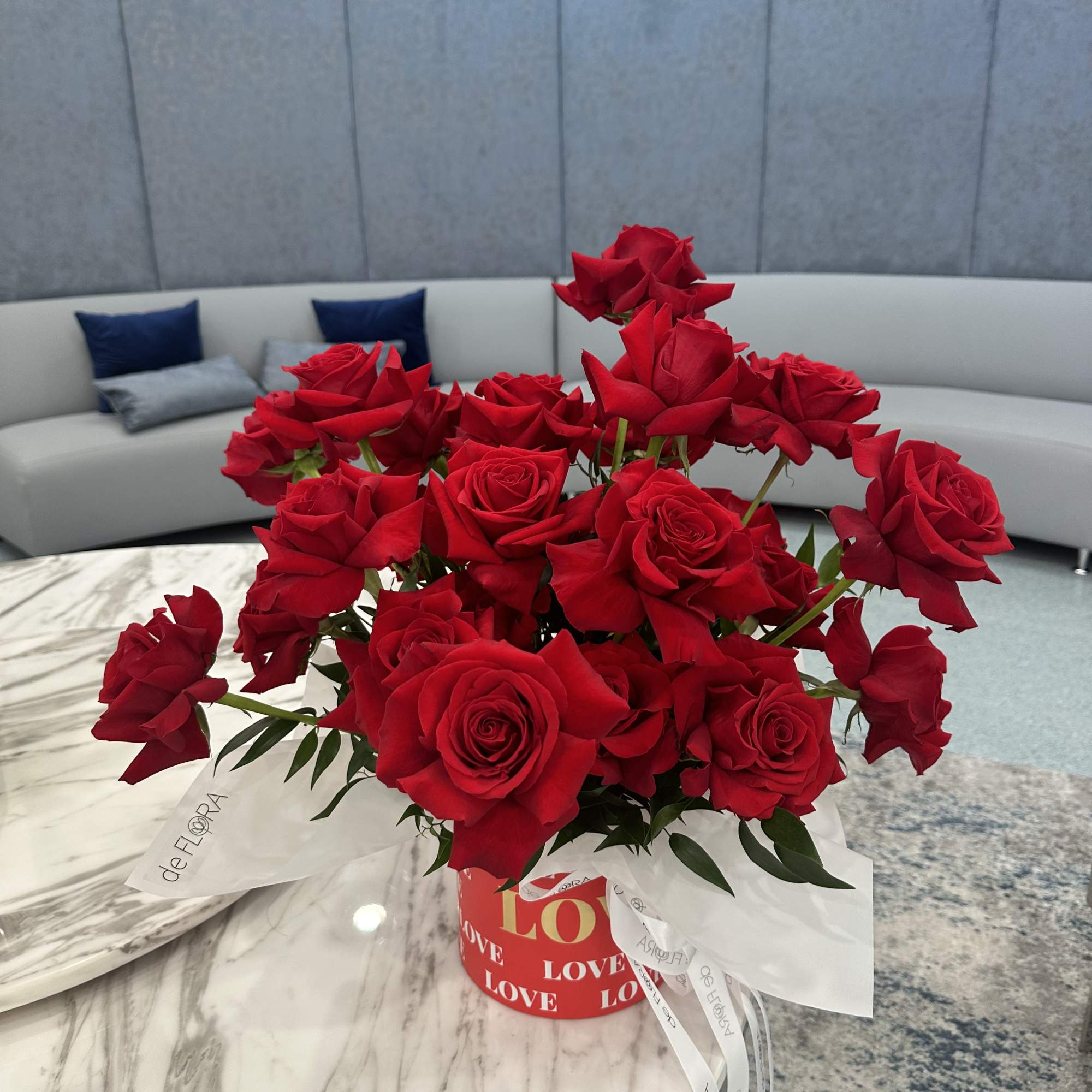 Bouquet of red roses in a red heart-themed box