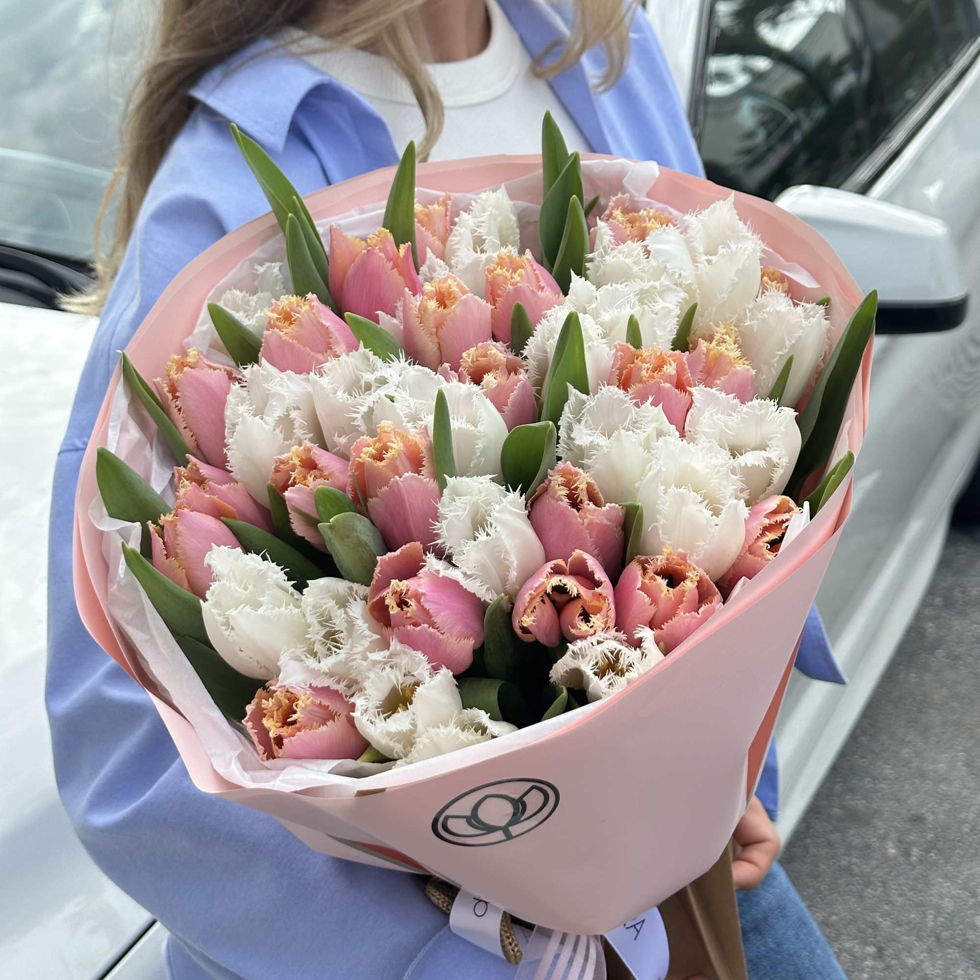 Pink and white tulip bouquet wrapped in pastel pink paper