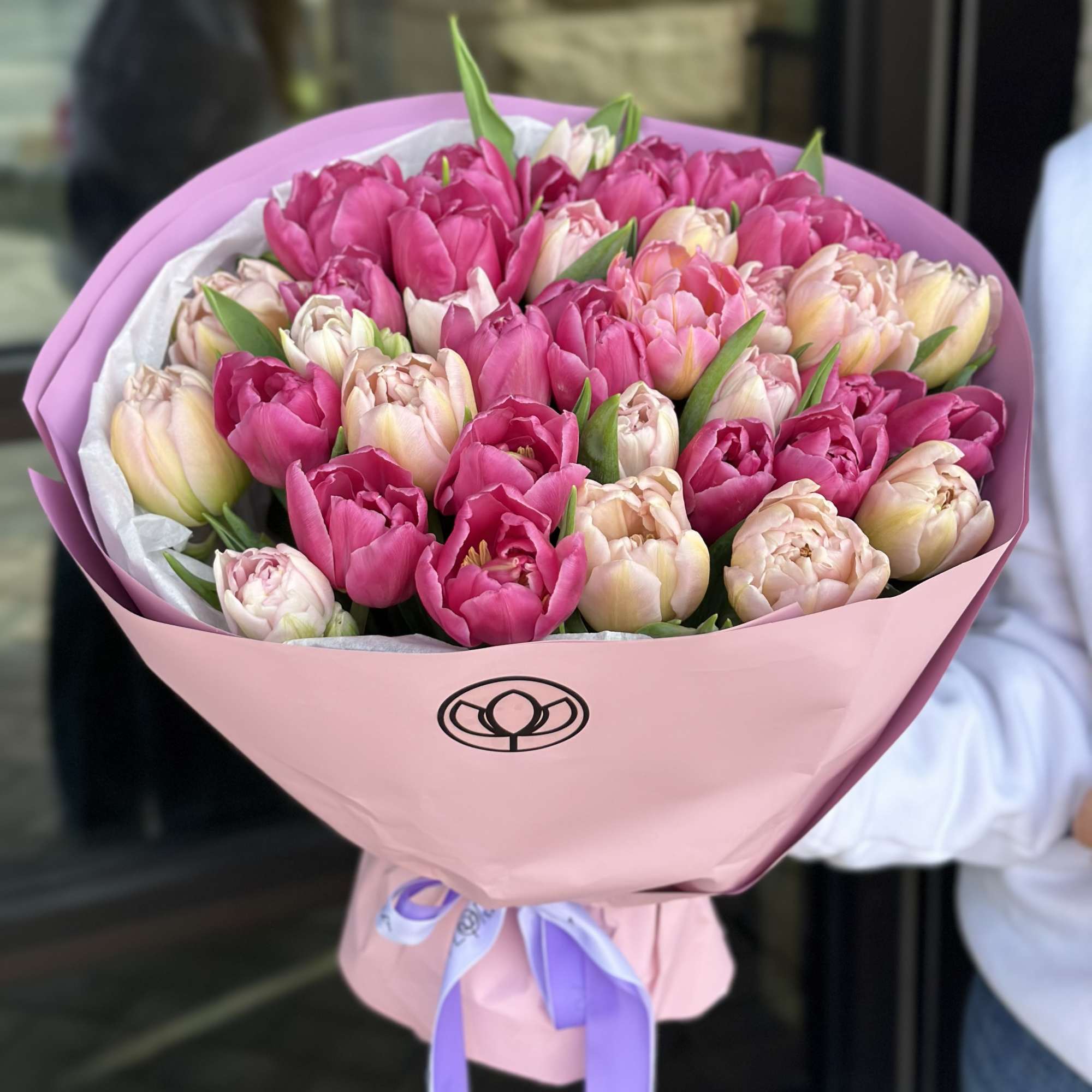 Bouquet of pink and blush tulips wrapped in pink paper, photo 2 of 3