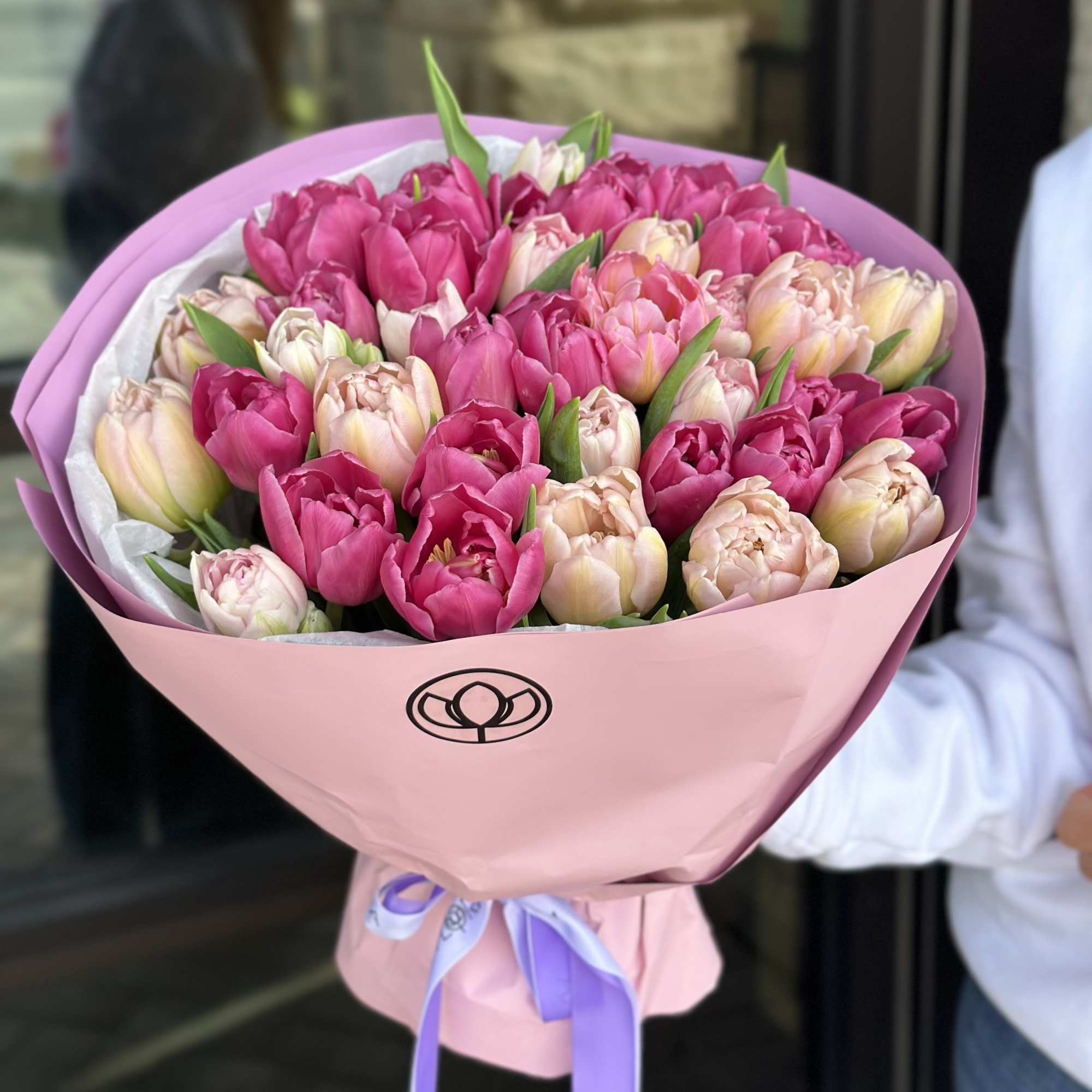 Bouquet of pink and blush tulips wrapped in pink paper, photo 3 of 3