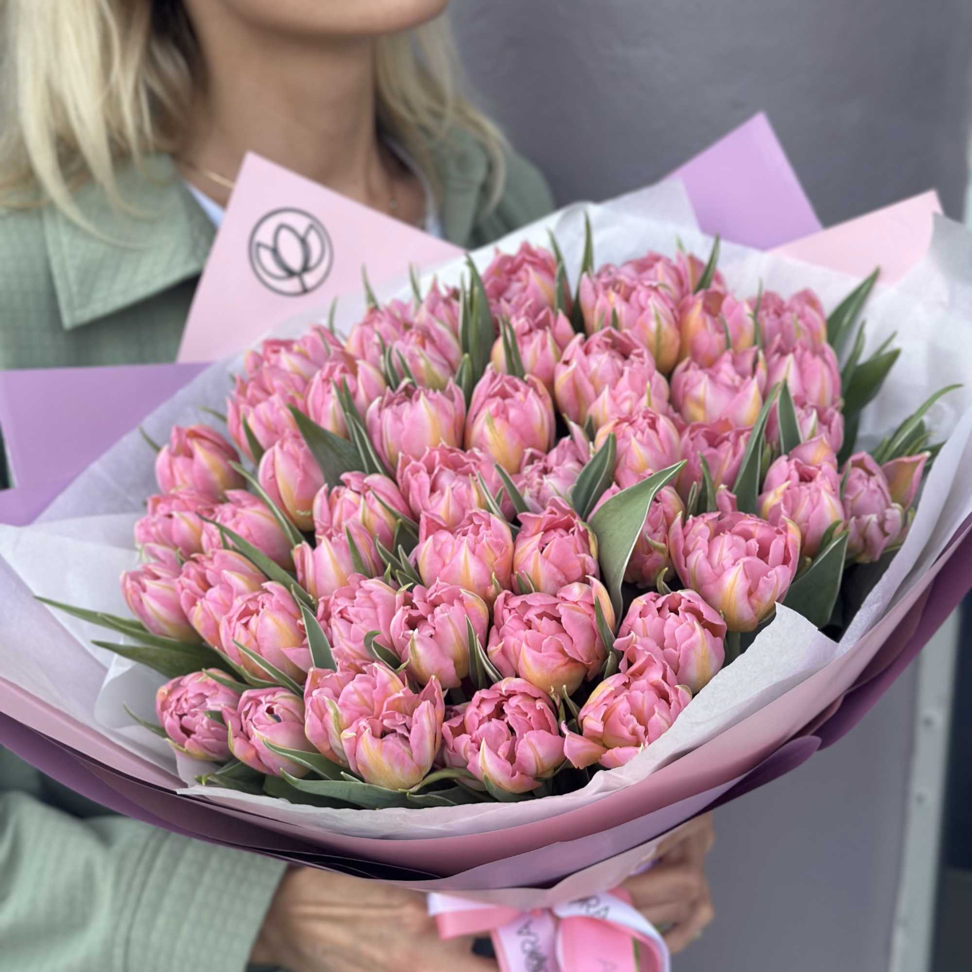 Bouquet of pink tulips wrapped in pastel paper