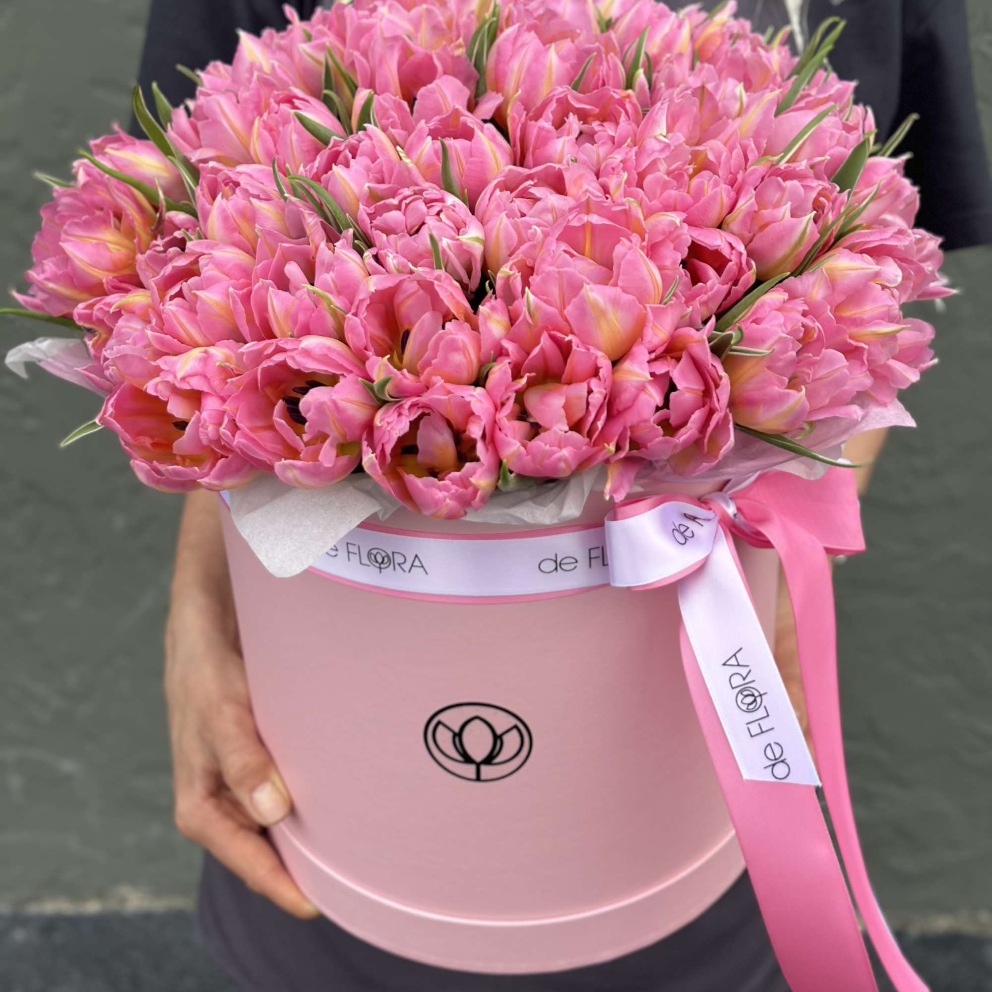 Large pink tulip bouquet in a round pink box with ribbon