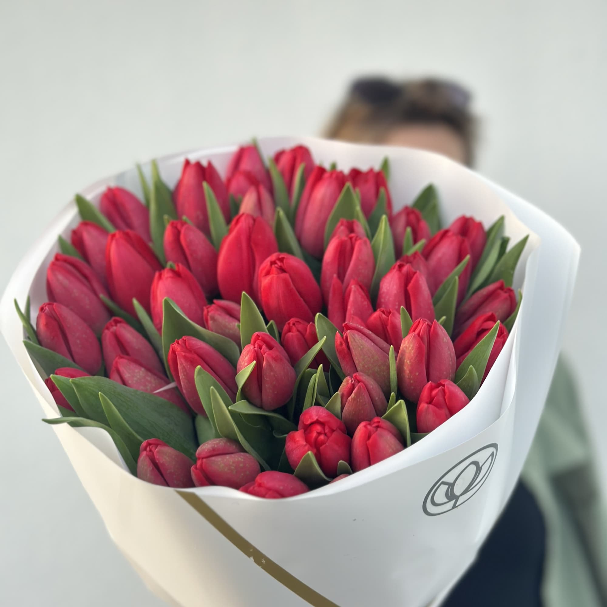 Bouquet of red tulips wrapped in white paper, photo 3 of 3