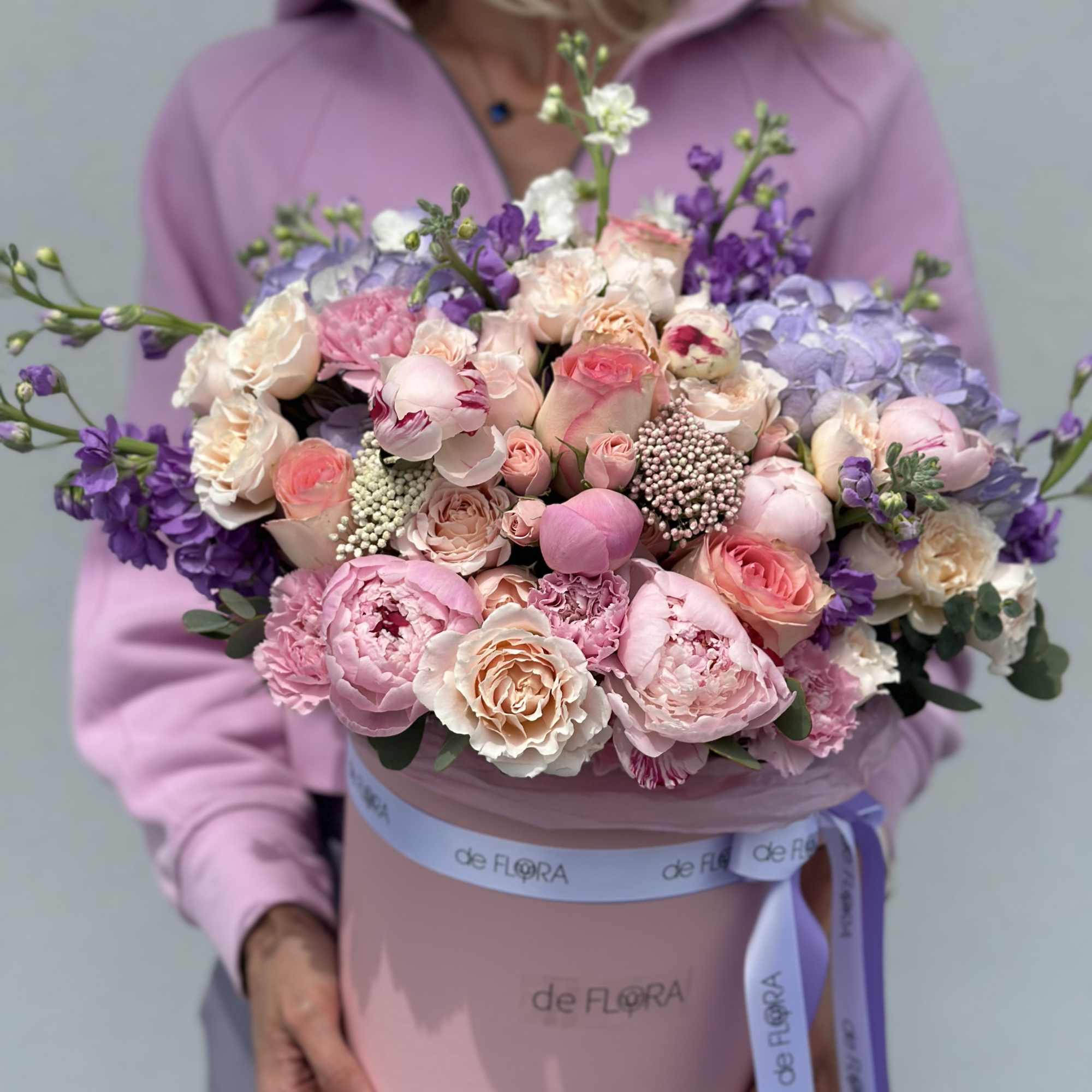 Large pink and purple bouquet in a round hatbox with ribbon