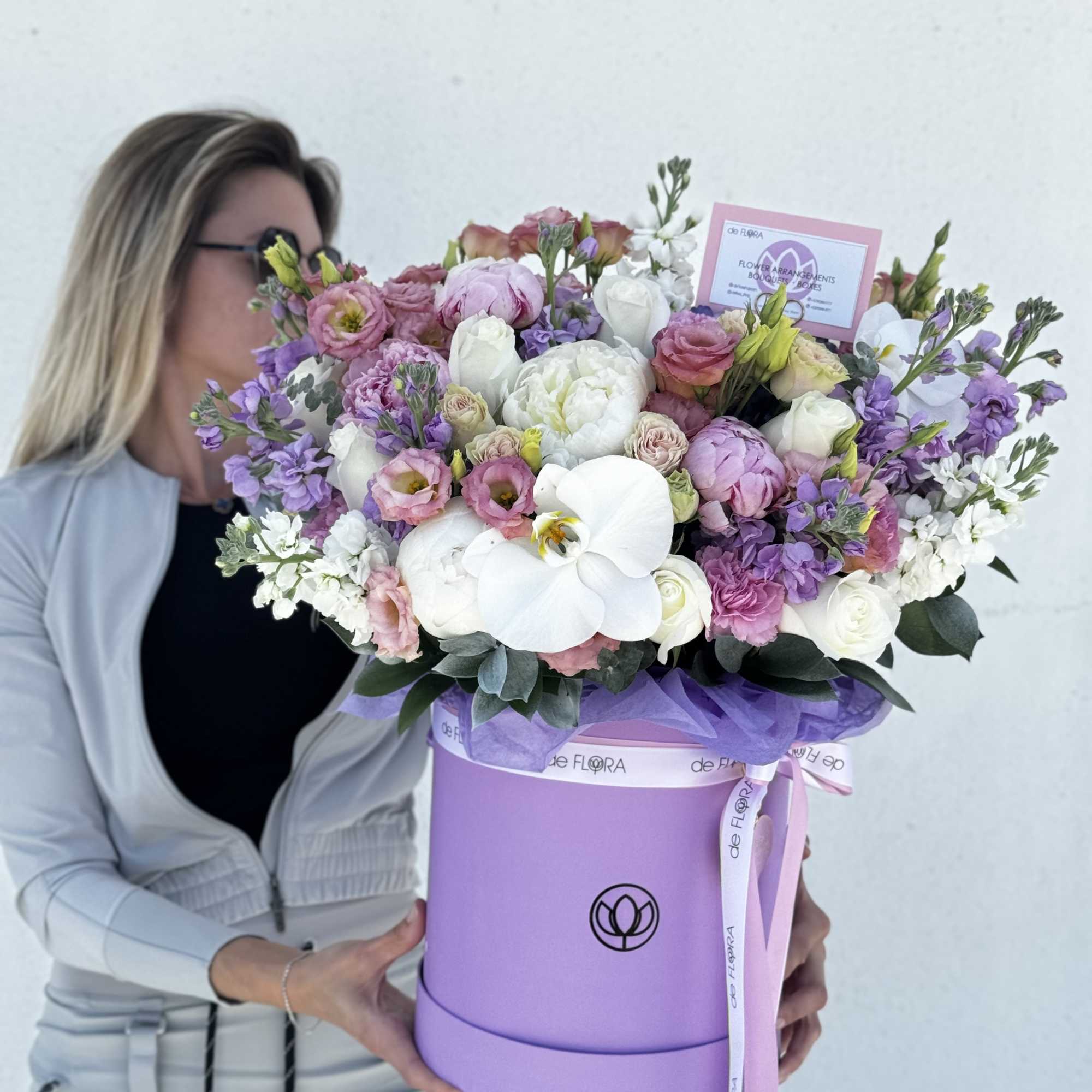 Large pastel bouquet in a lavender hat box with white orchids and pink flowers