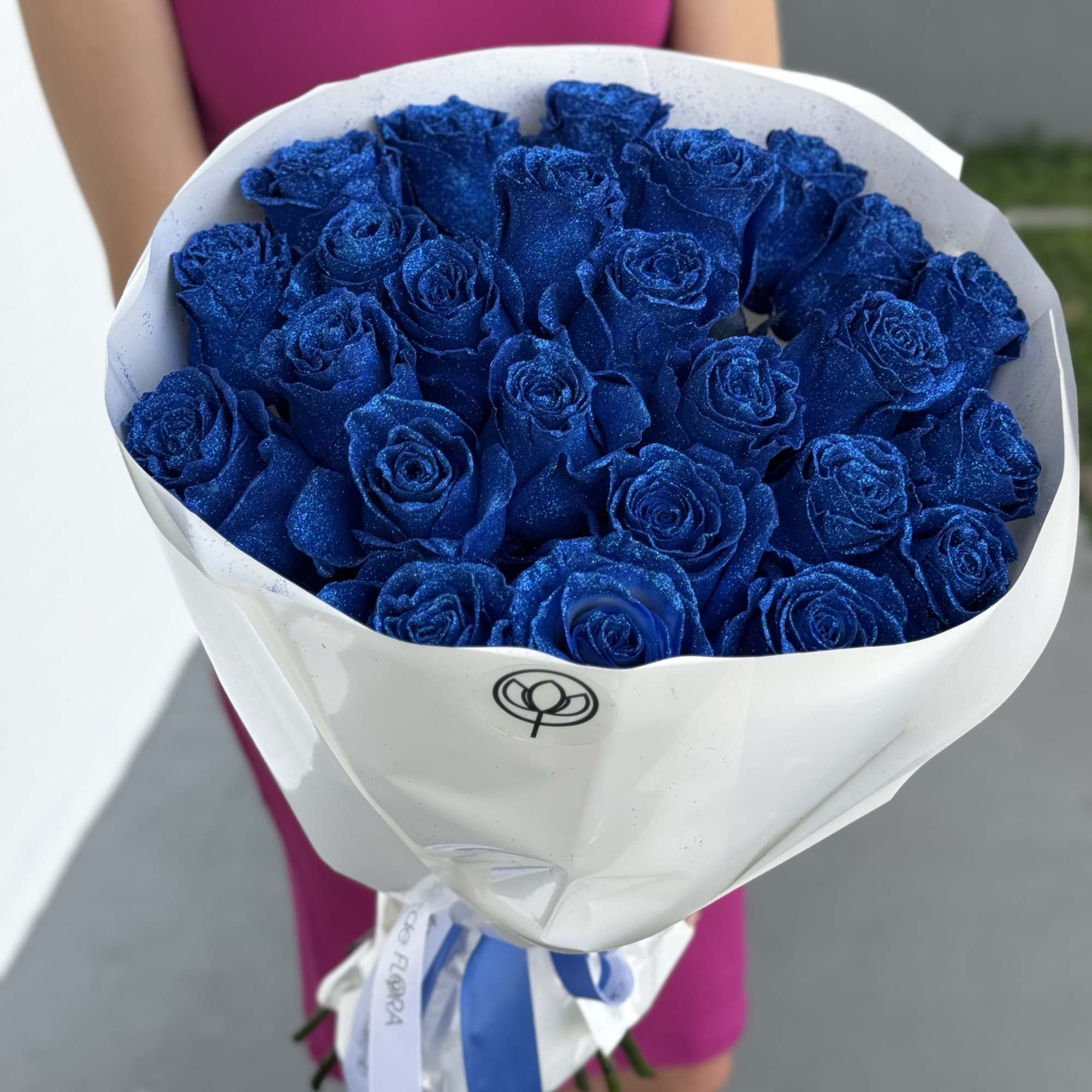 Bouquet of glittery blue roses wrapped in white paper