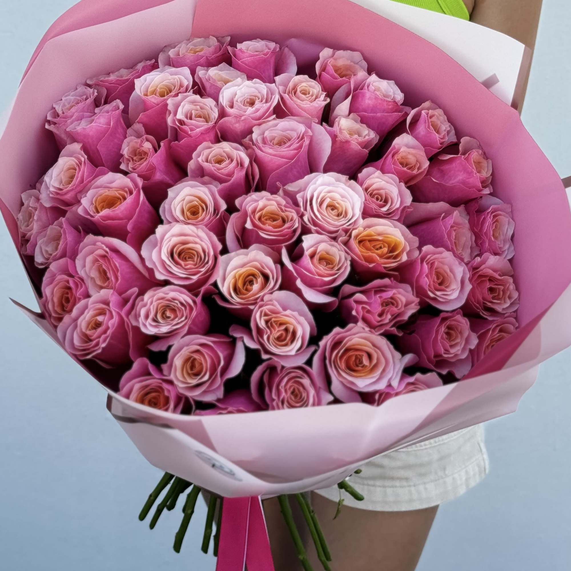 Large bouquet of pink roses wrapped in pink paper