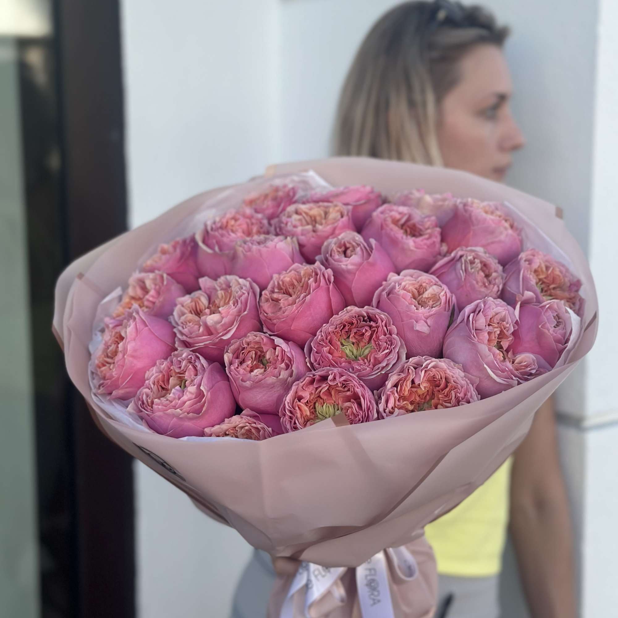 Large bouquet of pink roses wrapped in blush paper