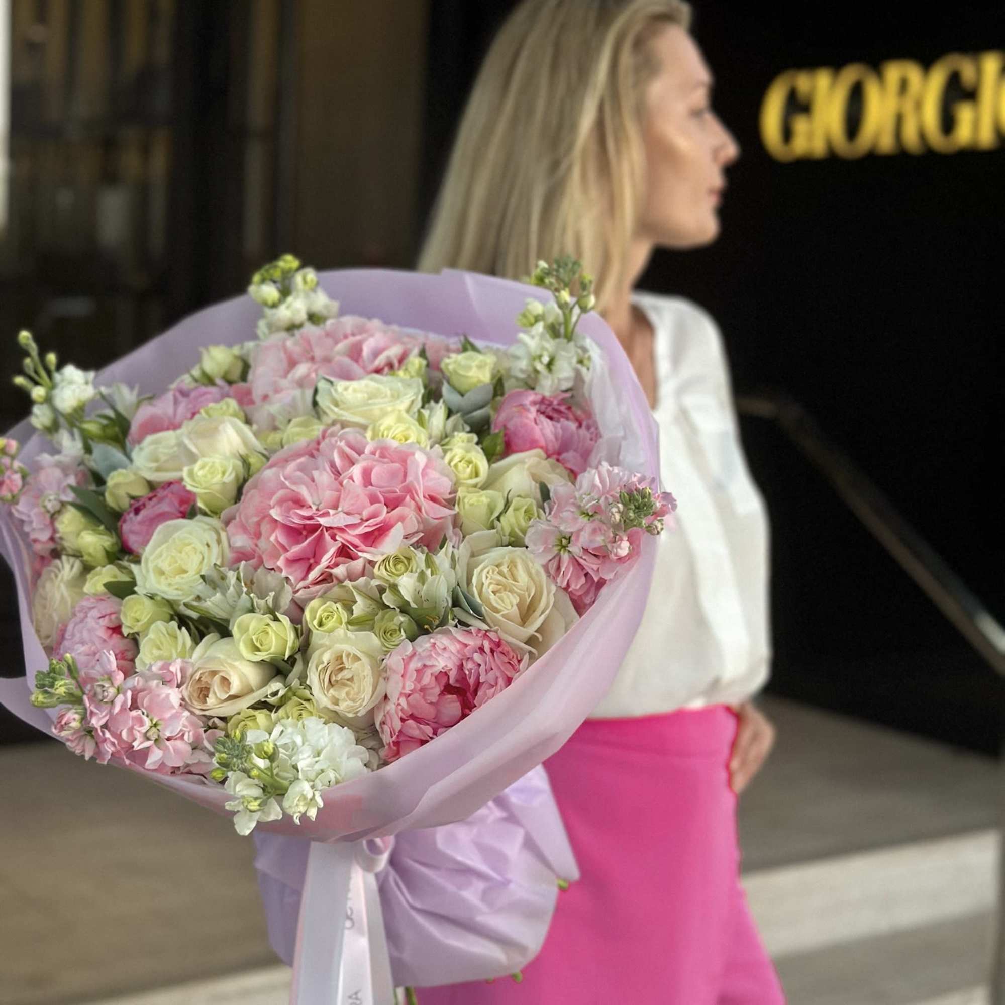 Large pink and white bouquet wrapped in lavender paper