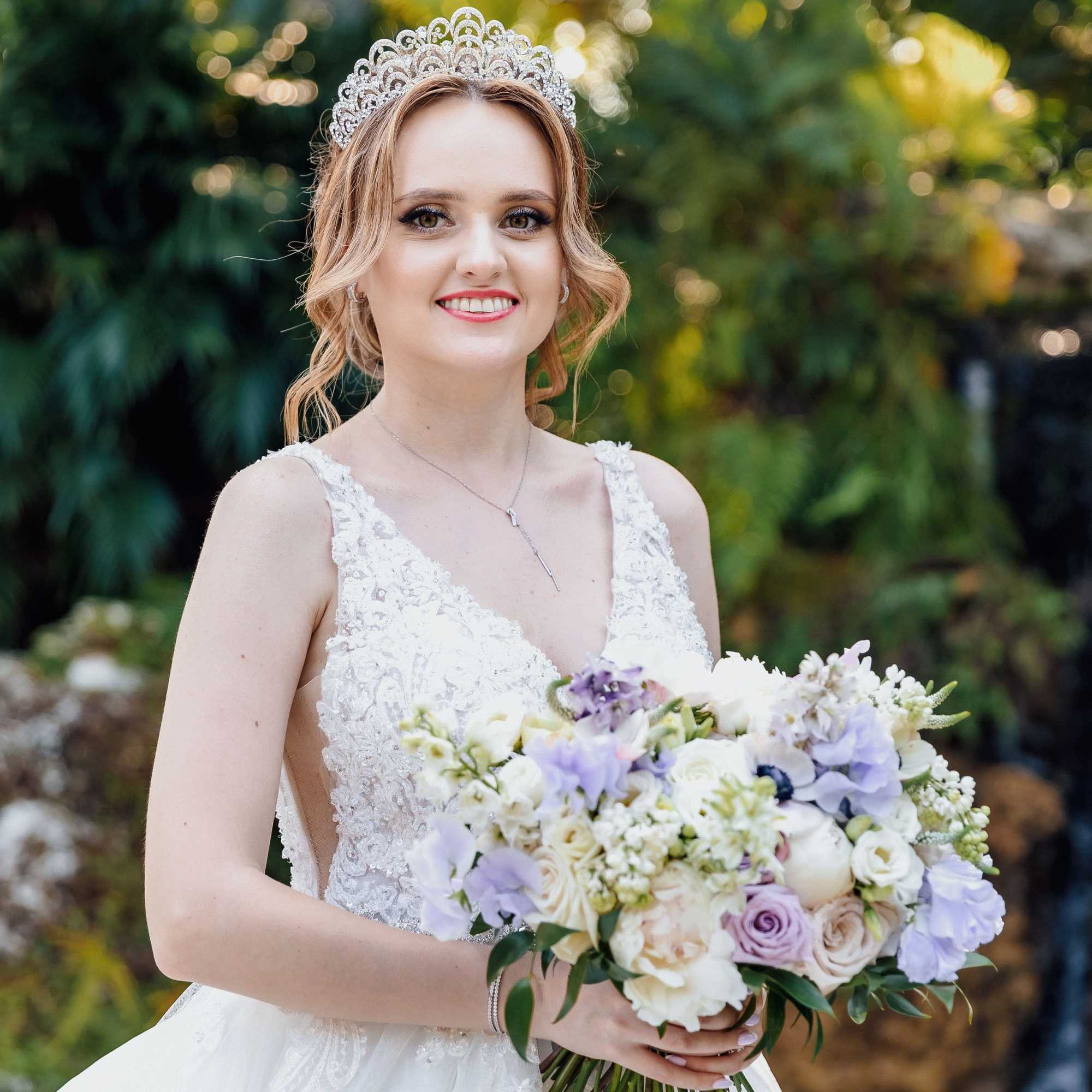 Bride holding a pastel bouquet and wearing a jeweled tiara