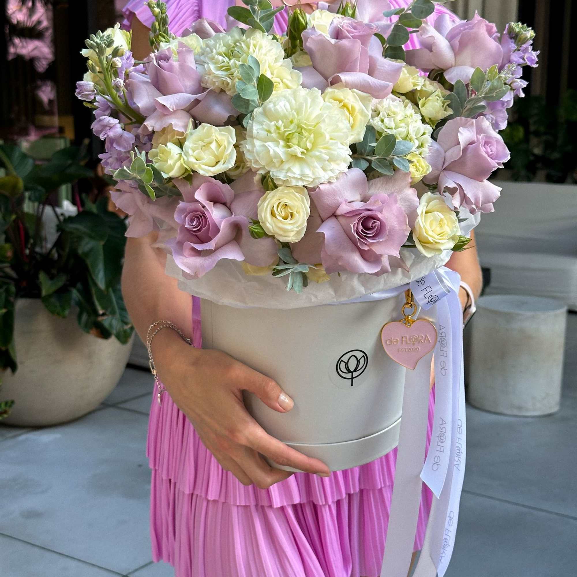 Lavender and cream bouquet in a round hatbox with ribbon