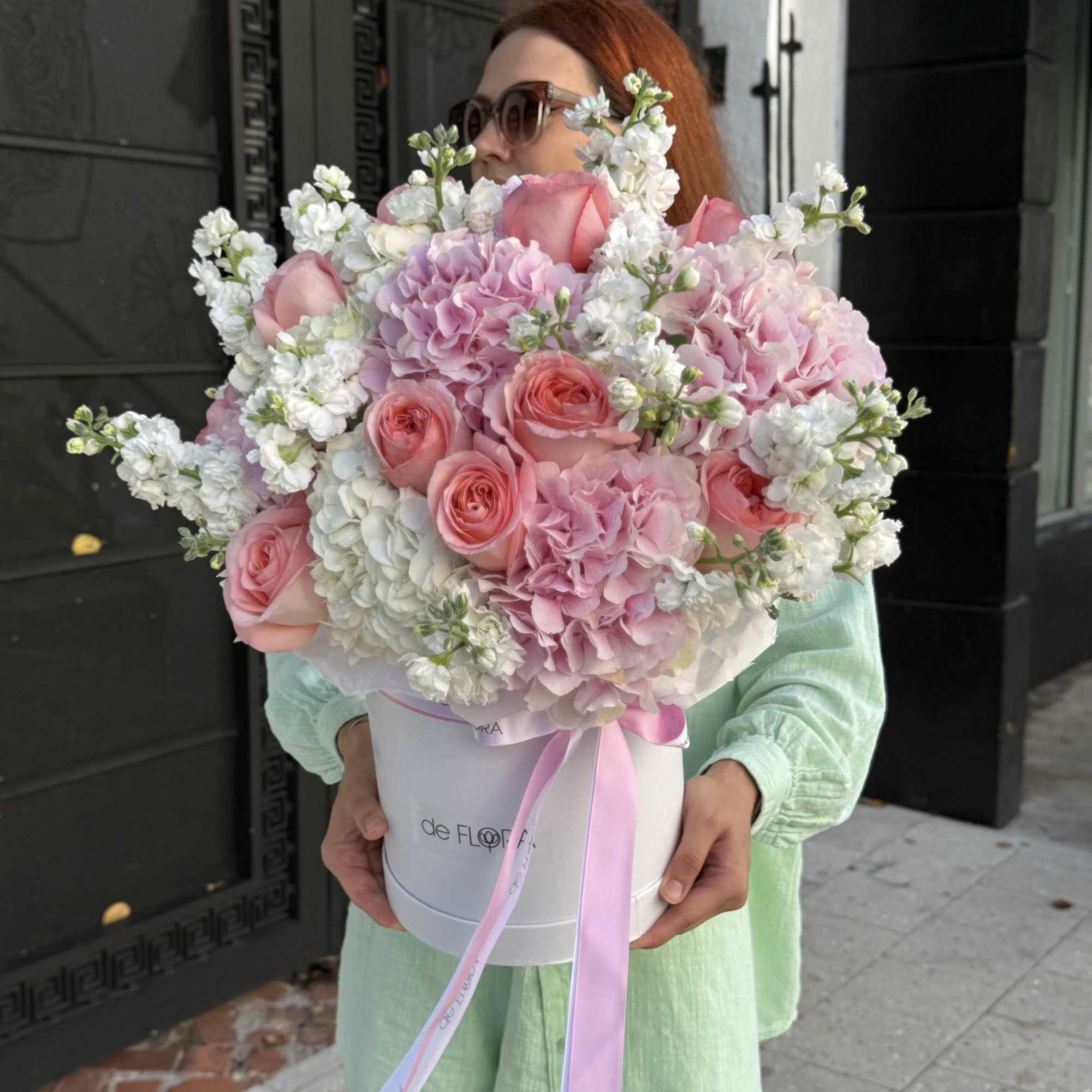 Large pink and white bouquet in a round box with ribbon