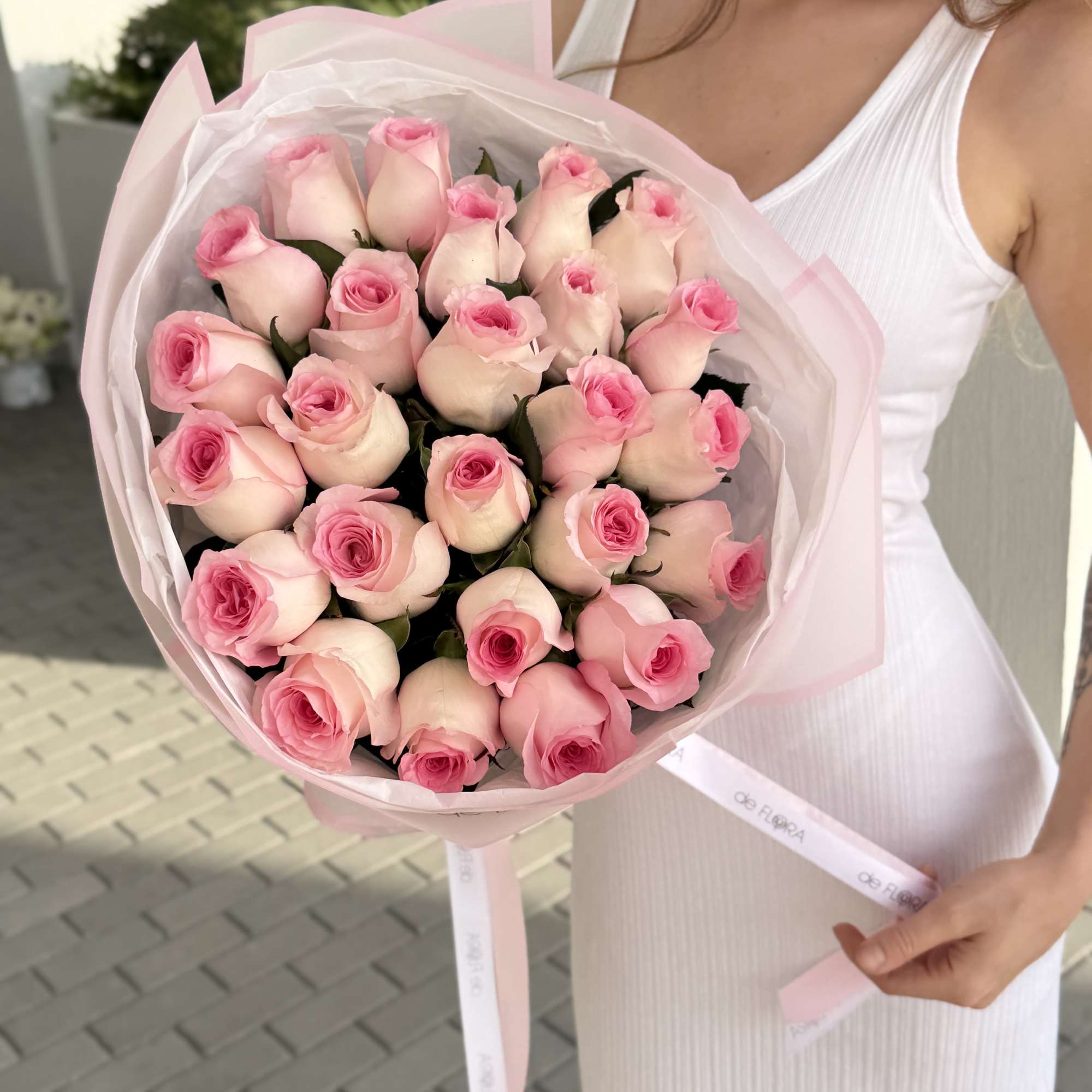 Bouquet of pale pink roses wrapped in pink paper