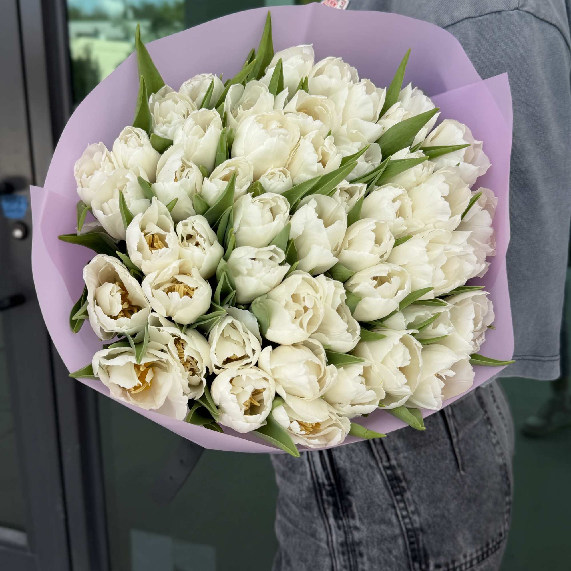Bouquet of white tulips wrapped in lavender paper, photo 2 of 3