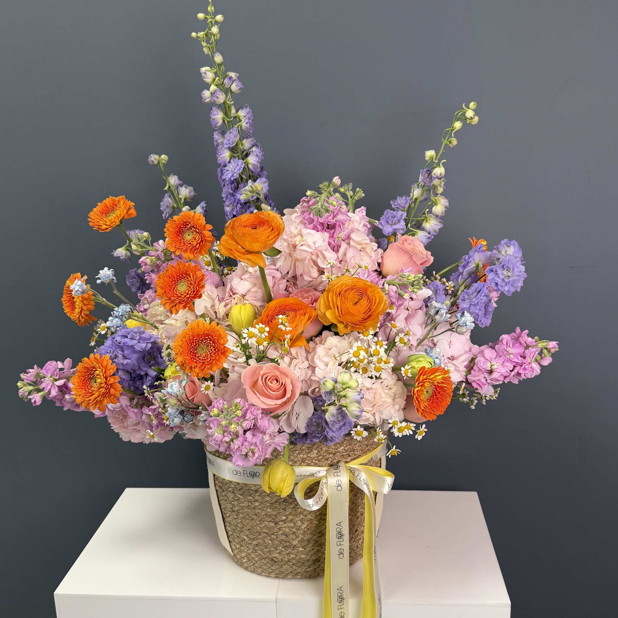 A vibrant, garden-style arrangement bursting with life and color. This basket features