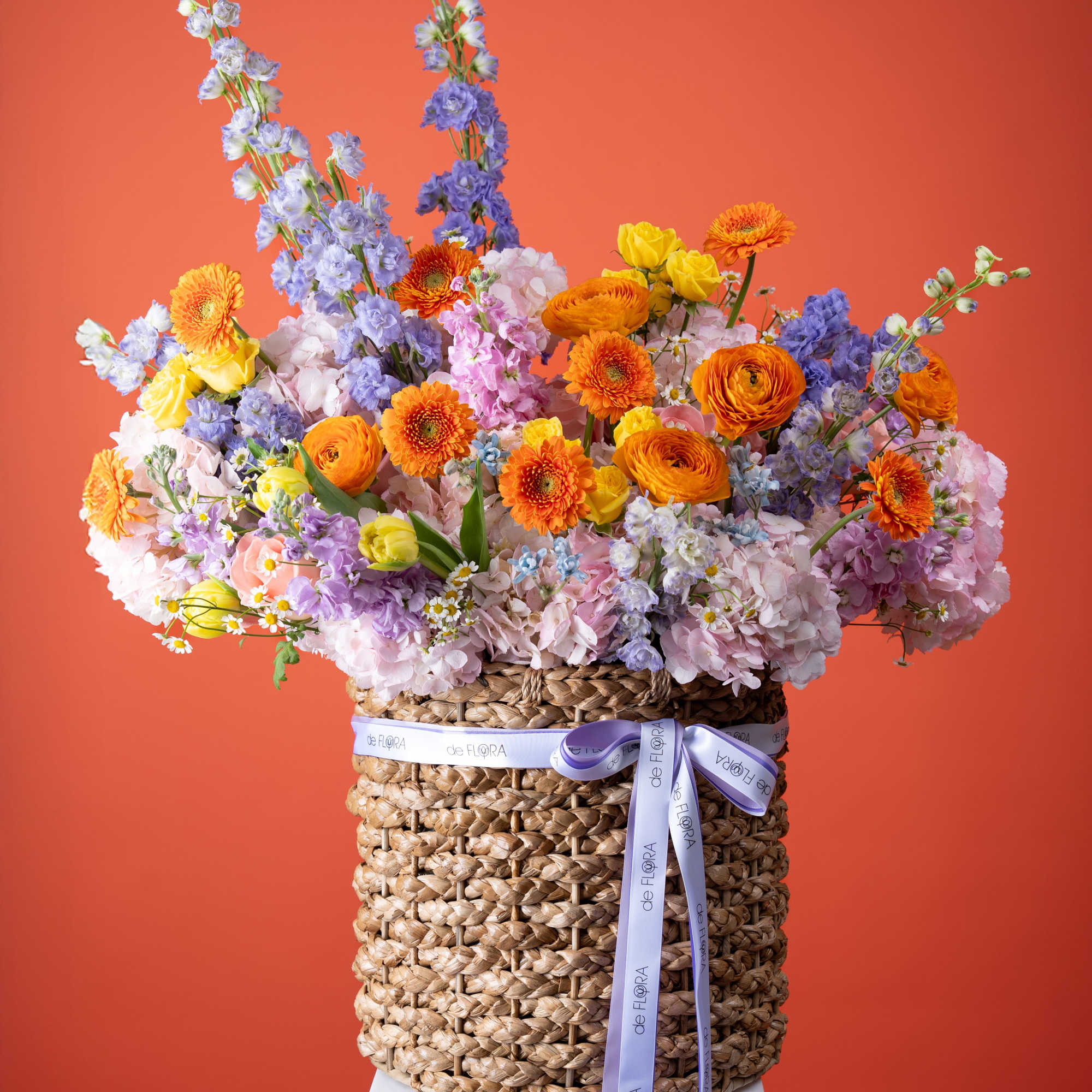Bright orange gerbera daisies and ranunculus set the tone in this Sunset