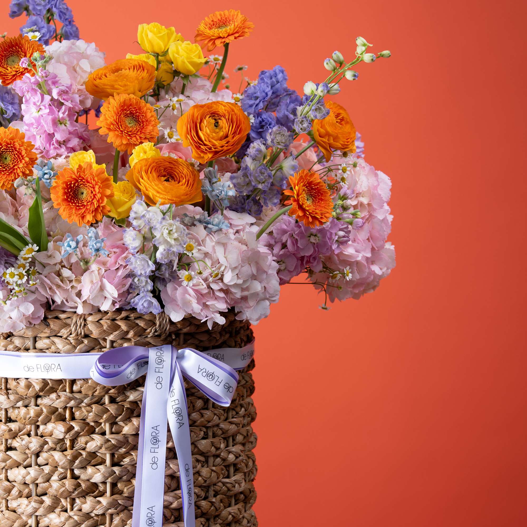Bright orange gerbera daisies and ranunculus set the tone in this Sunset, photo 2 of 4