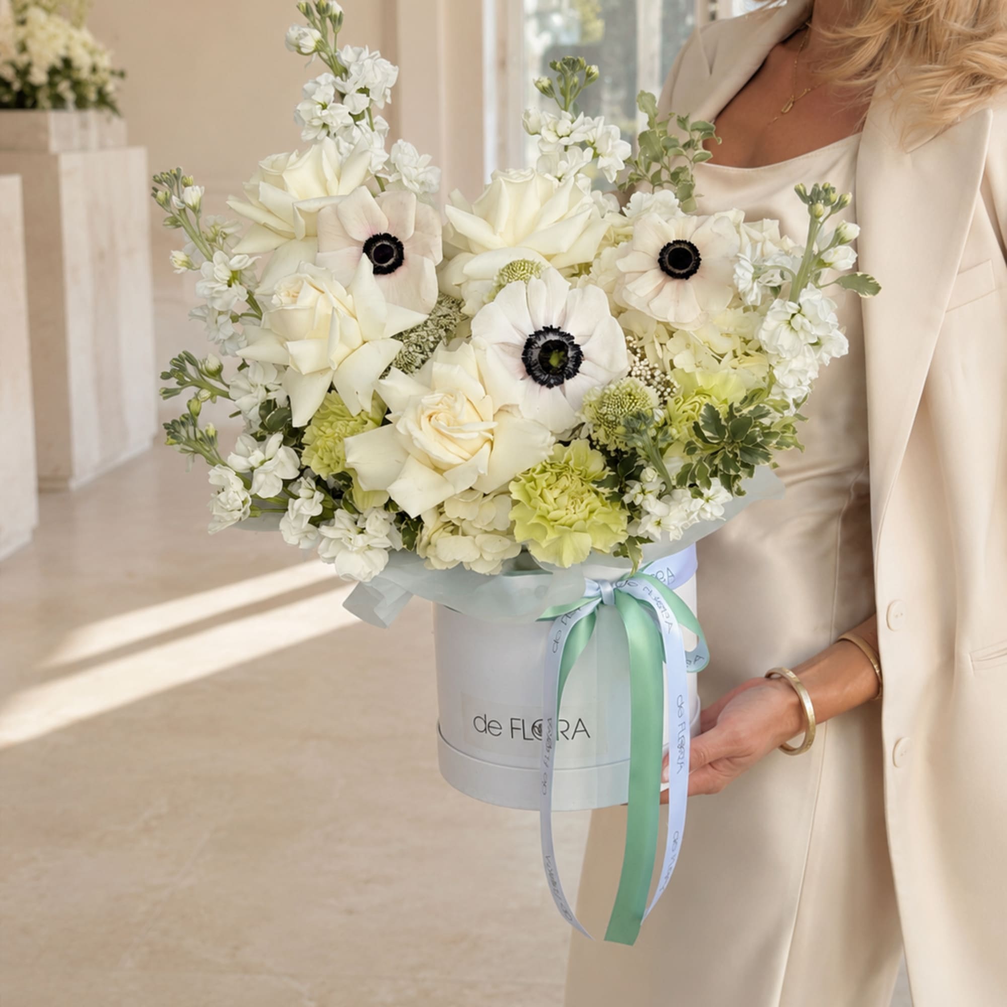 An exquisite arrangement of creamy white roses, delicate anemones with deep contrasting, photo 3 of 3