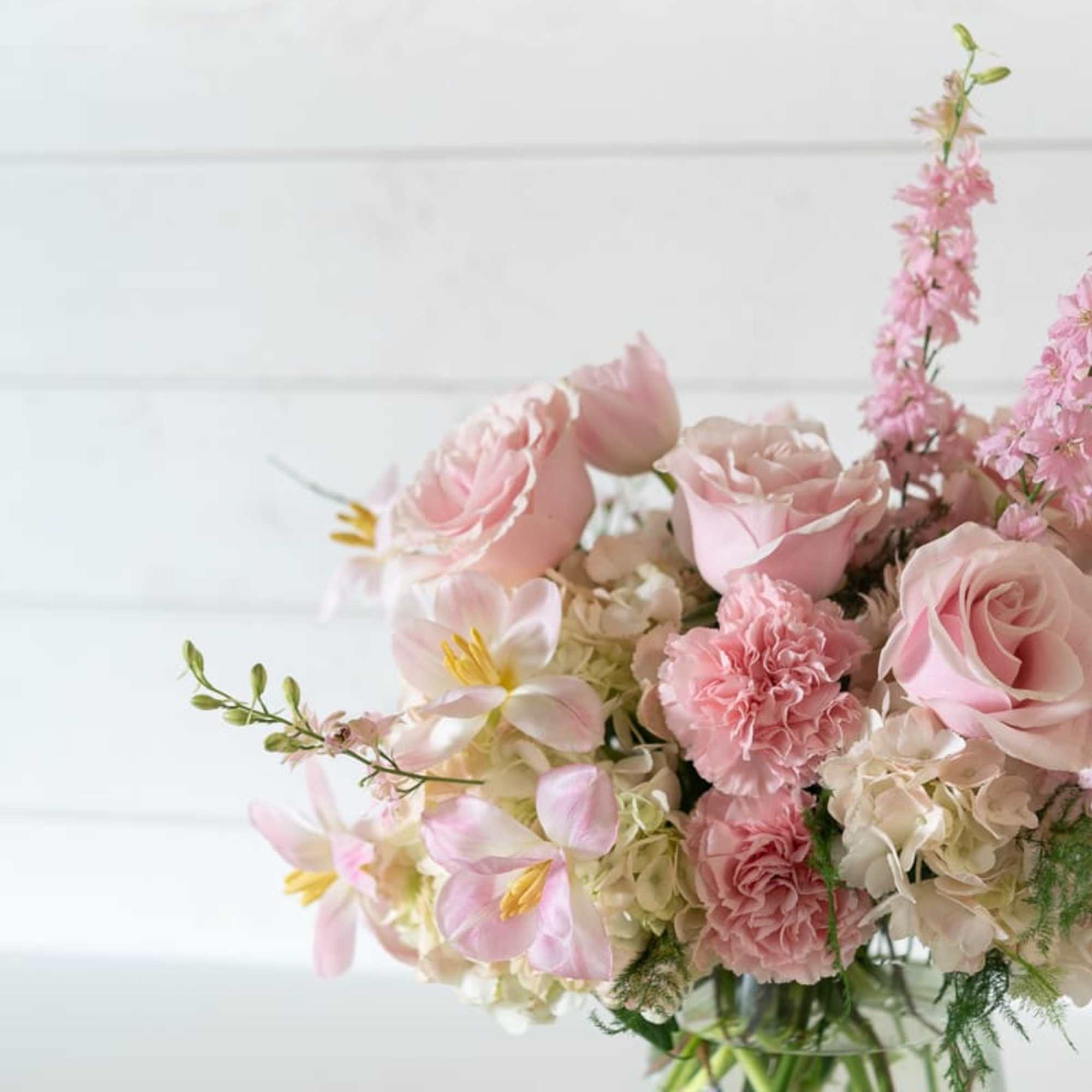 Pink floral bouquet in a clear glass vase