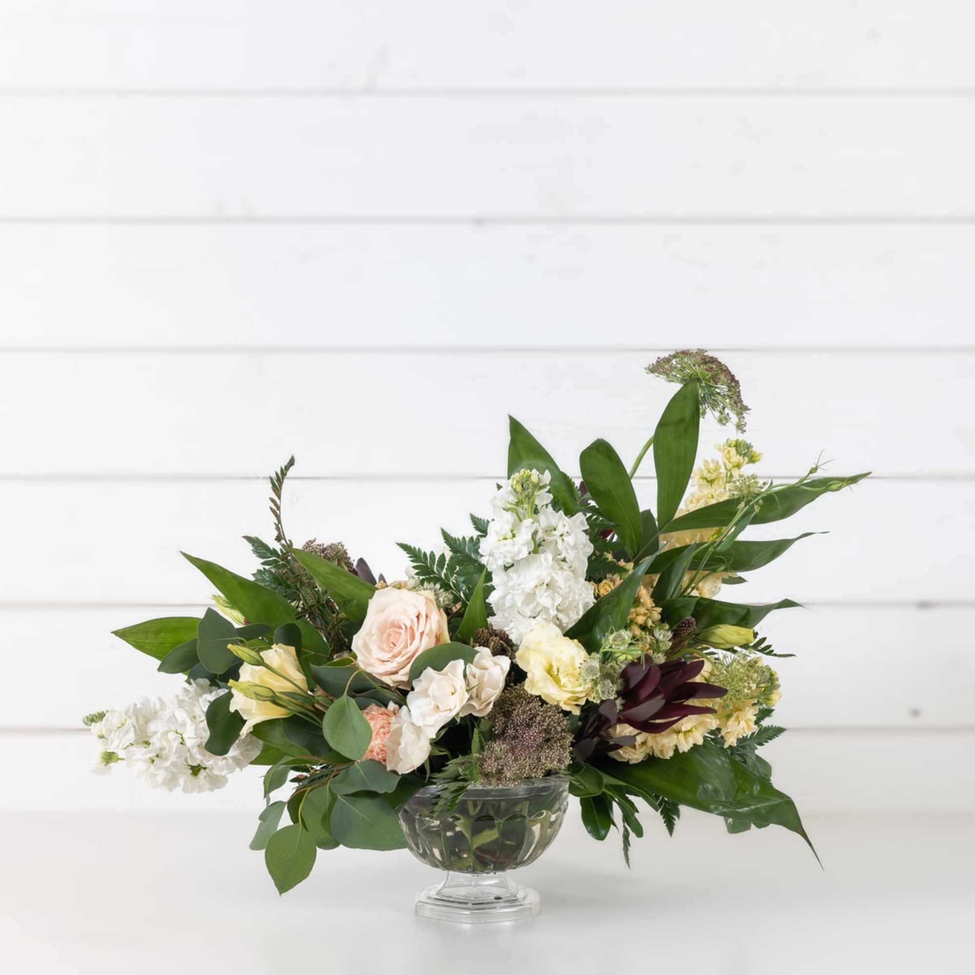 Mixed pastel flower arrangement in a clear glass vase