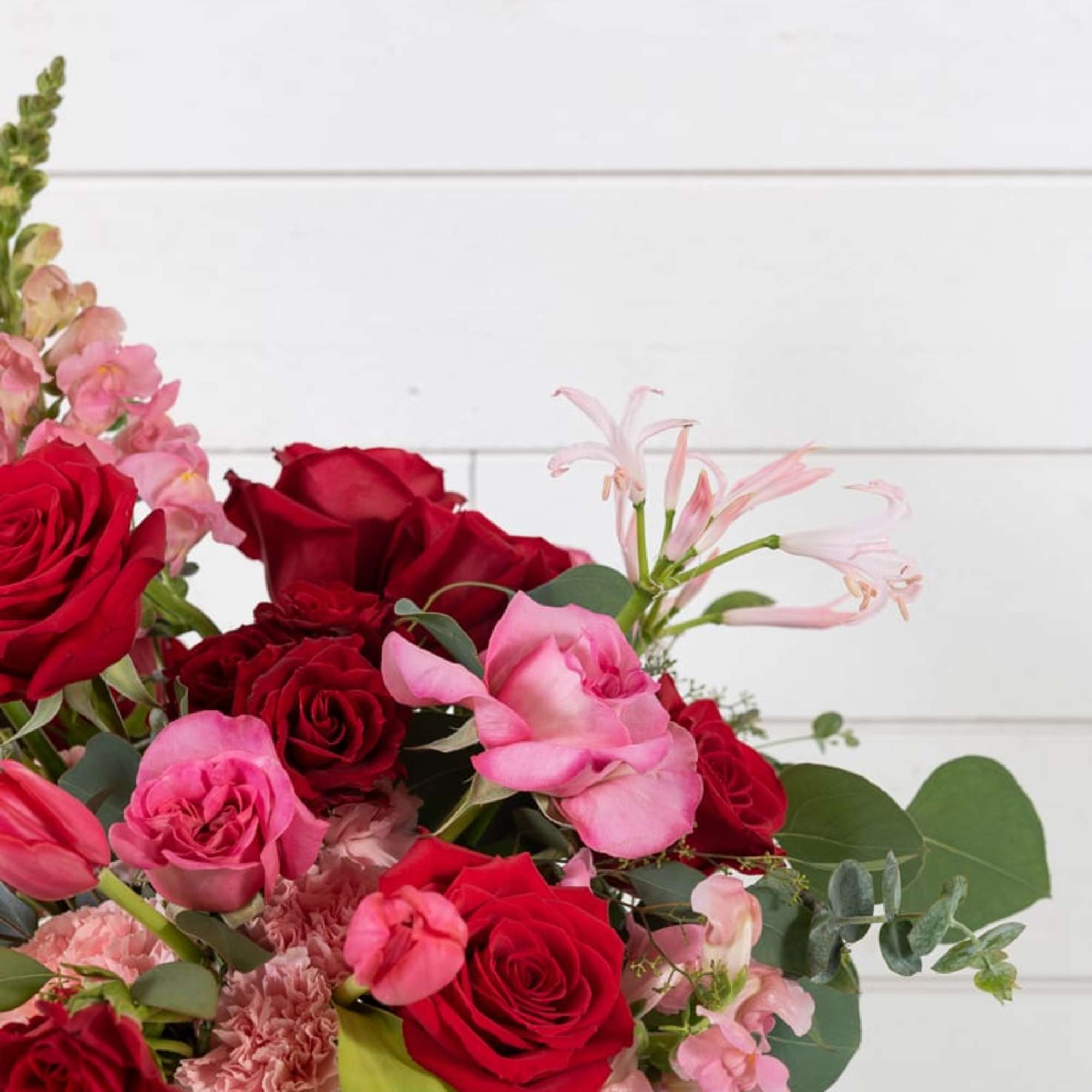 Bouquet of red and pink roses in a glass vase