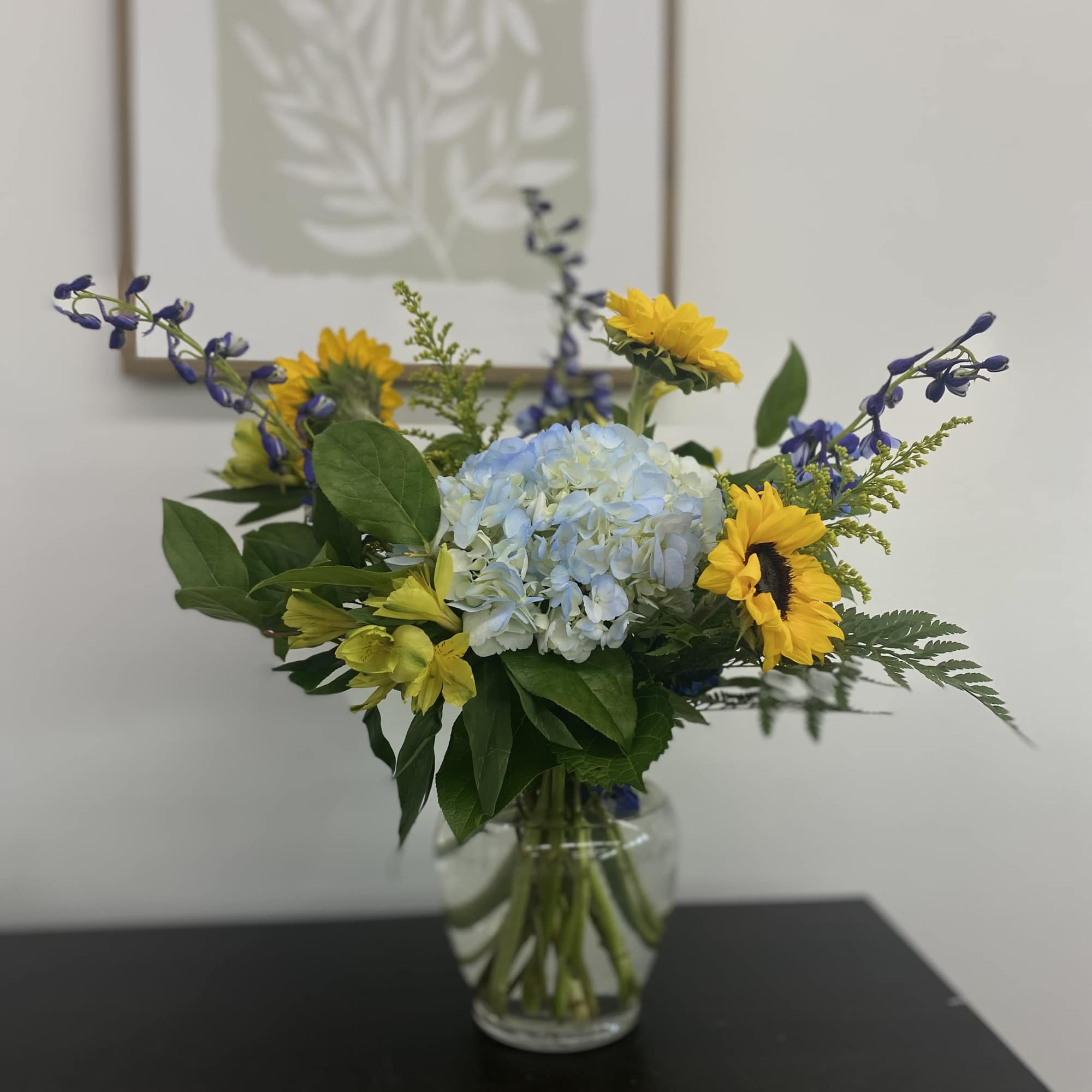 Welcome home a sweet baby boy with this bright and sunny arrangement.