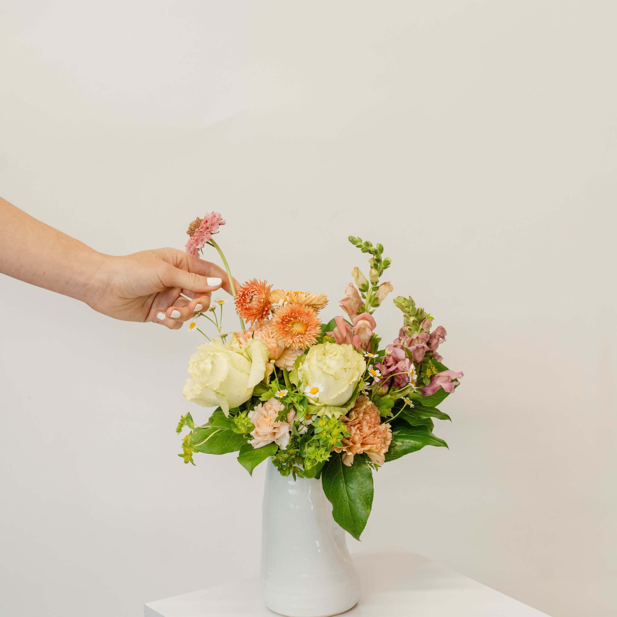 Mixed pastel bouquet in a white vase