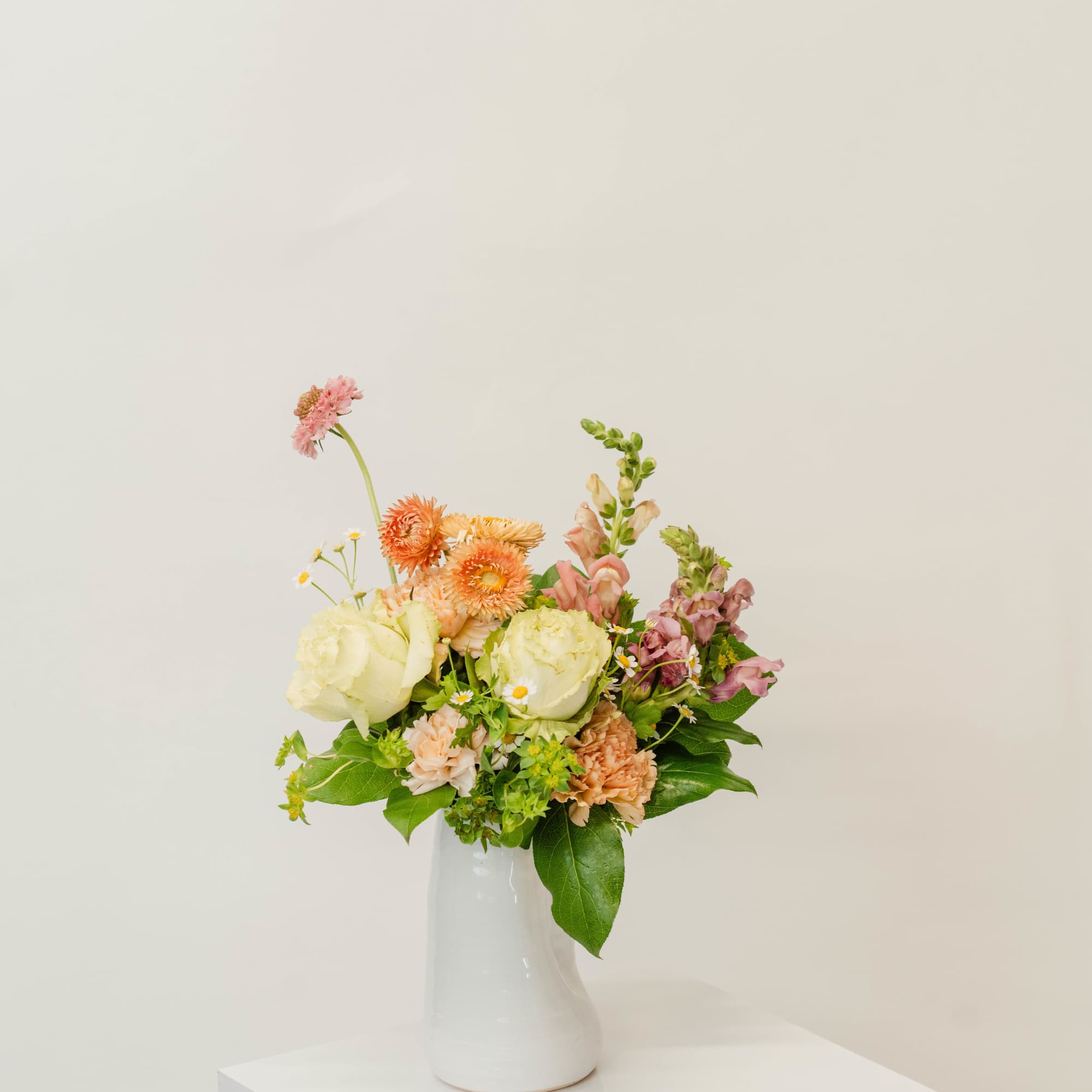 Mixed pastel bouquet in a white vase