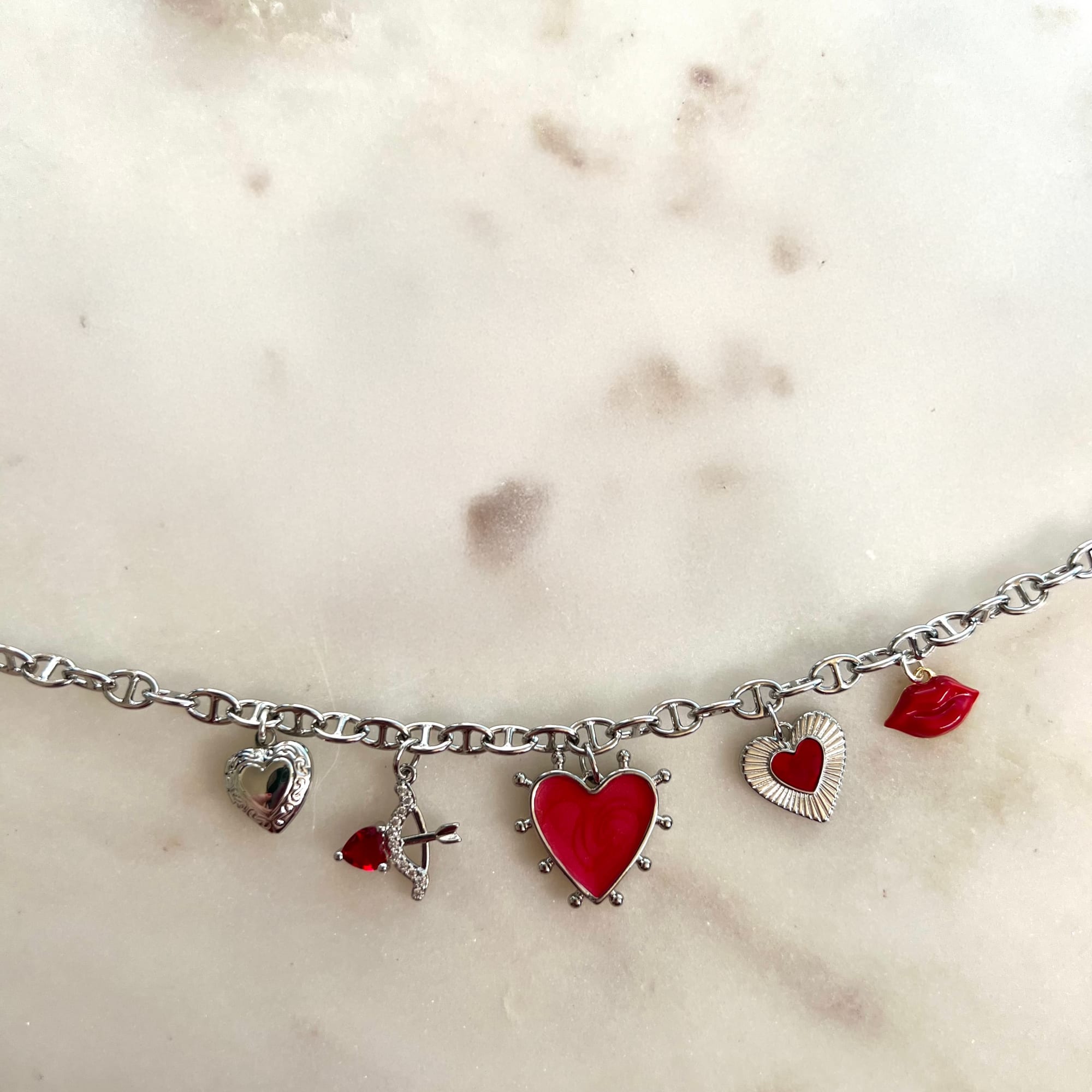 Silver charm bracelet with red heart and lips charms