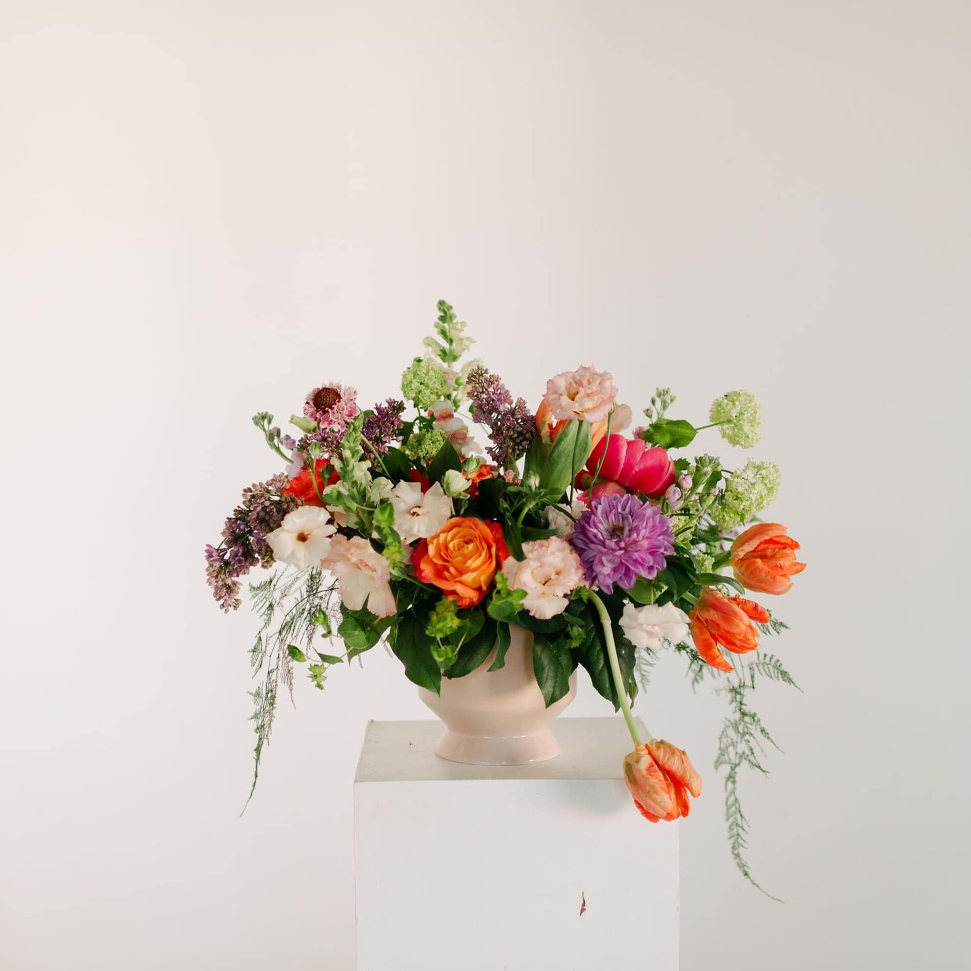 A lush blend of peaches, blush pinks, soft lavenders, and fresh greens