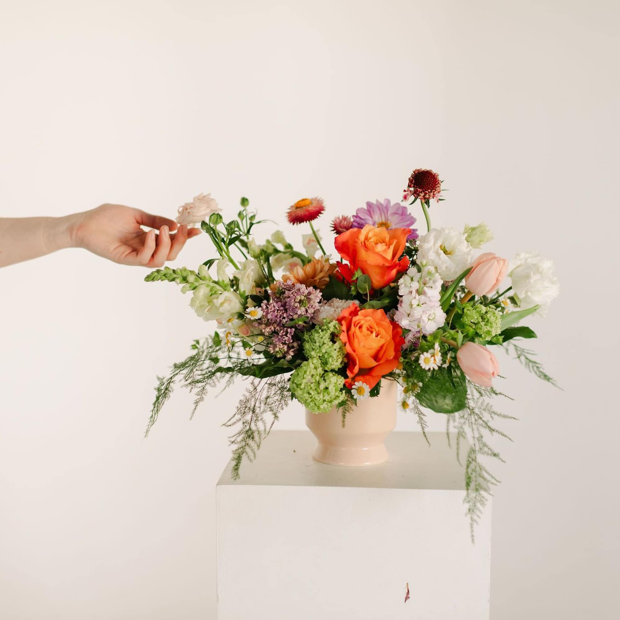 A lush blend of peaches, blush pinks, soft lavenders, and fresh greens