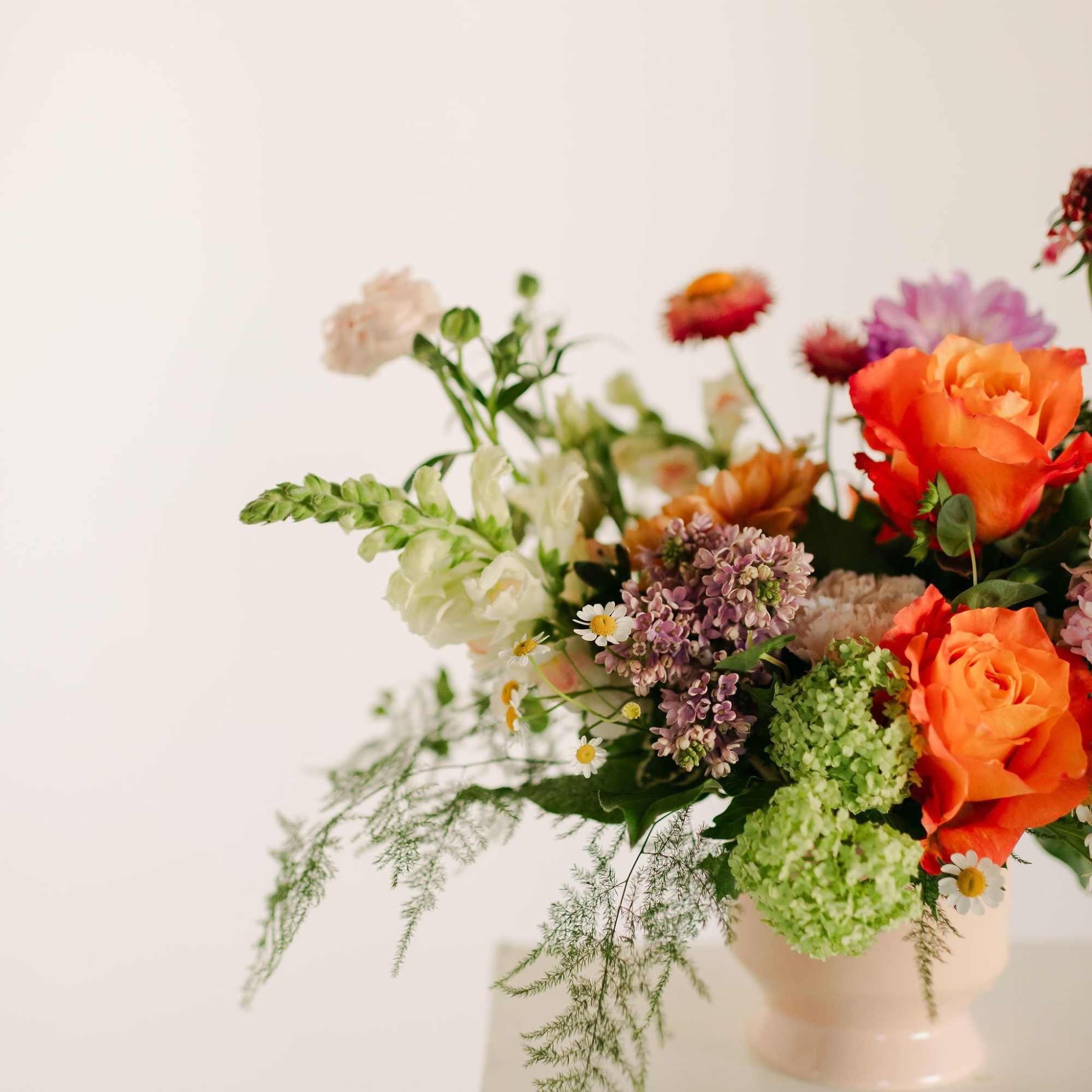 A lush blend of peaches, blush pinks, soft lavenders, and fresh greens