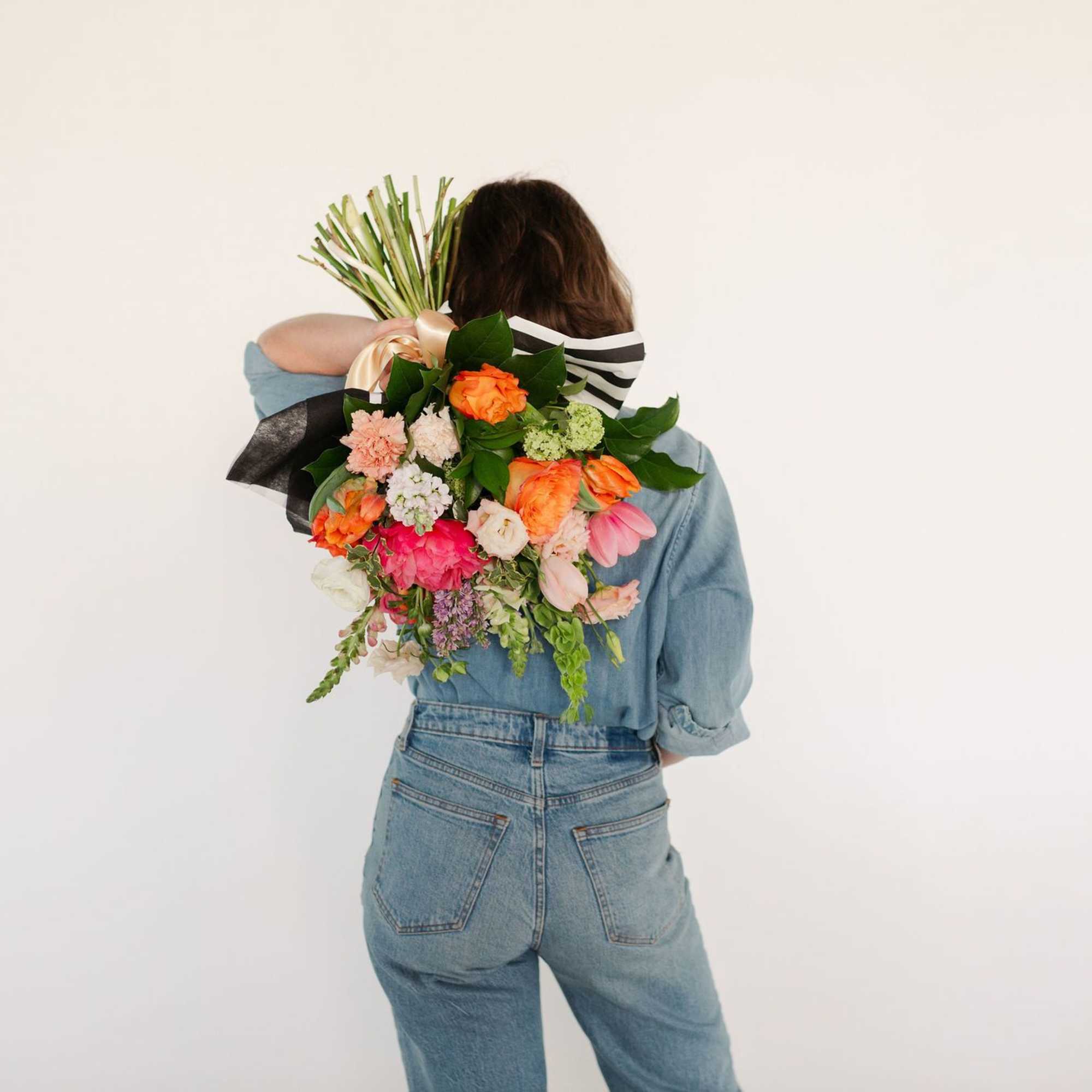 A stunning, premium hand-tied arrangement including coral charm peonies, fluffy lisianthus, lush