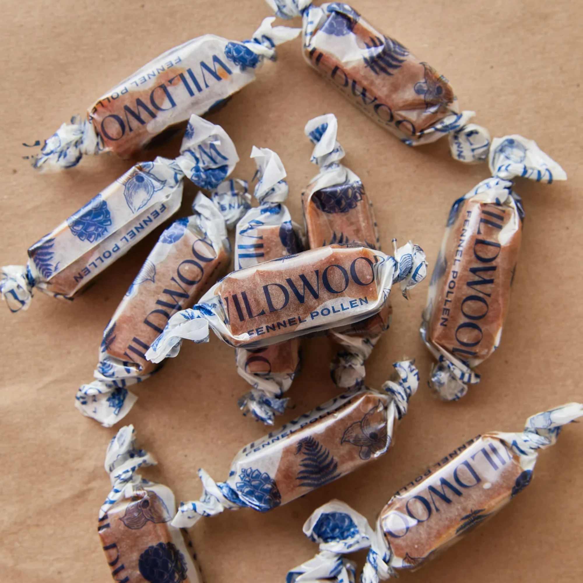 Wrapped fennel pollen candies scattered on brown paper