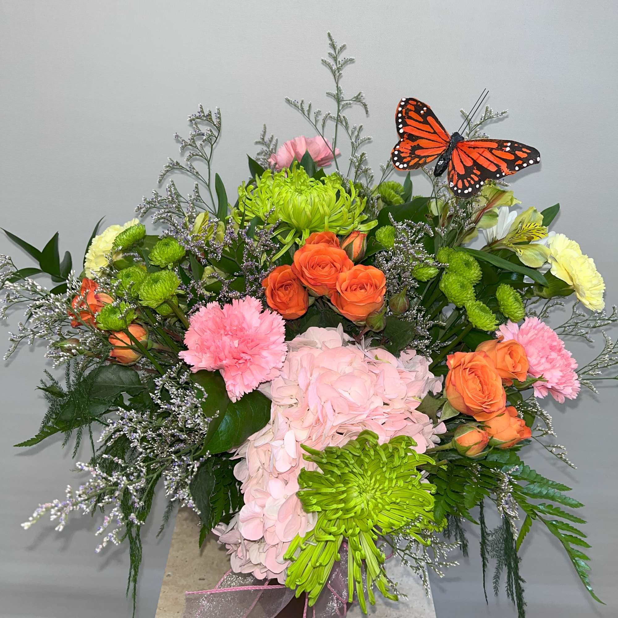Mixed bouquet with pink hydrangea, orange roses, and green chrysanthemums