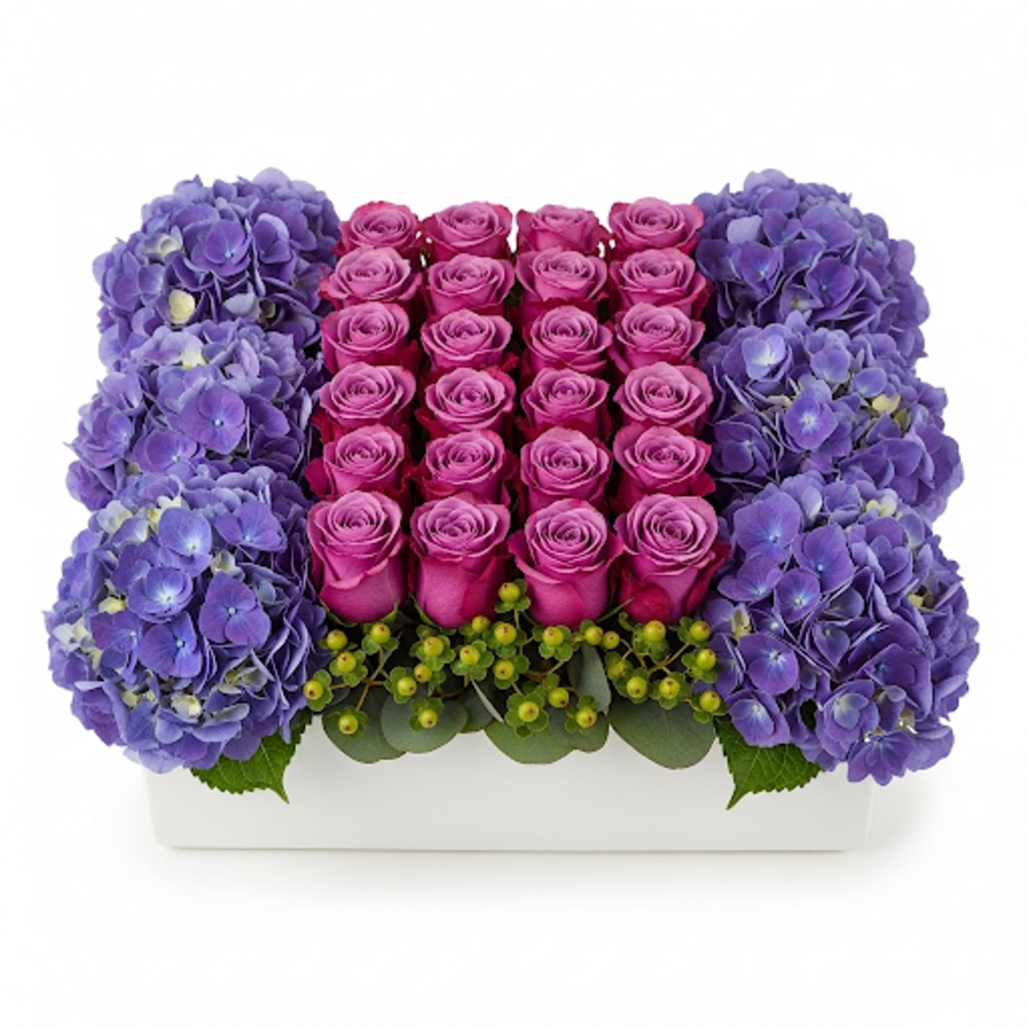 Pink roses framed by purple hydrangeas in a white box